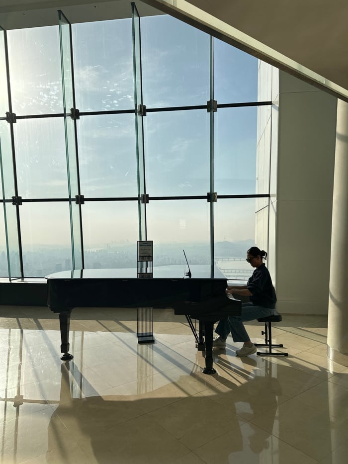 Morning visitors explore Seoul Sky observation deck glass floors