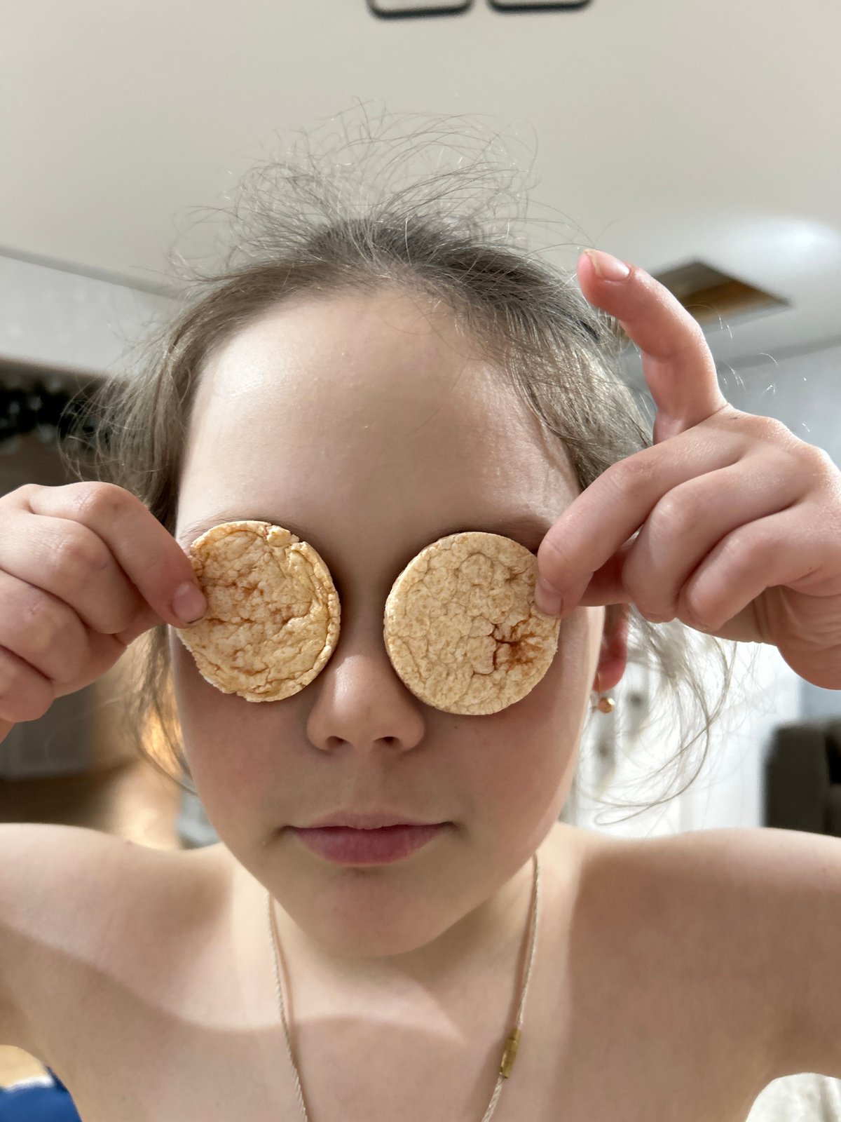 Child plays with rice crisps during photo session in Chaikovsky