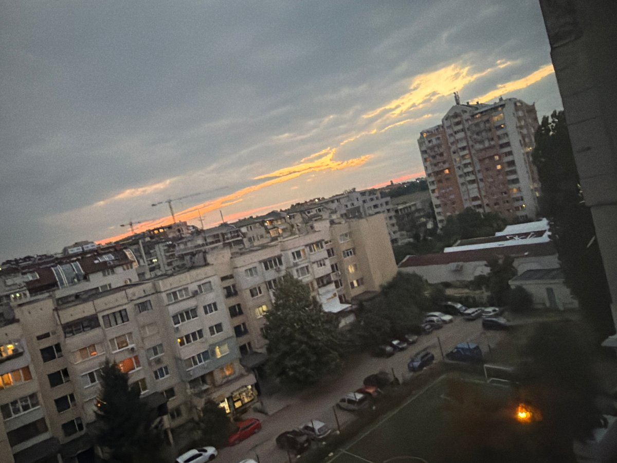 Sofia at dusk, city blocks under a glowing overcast sky
