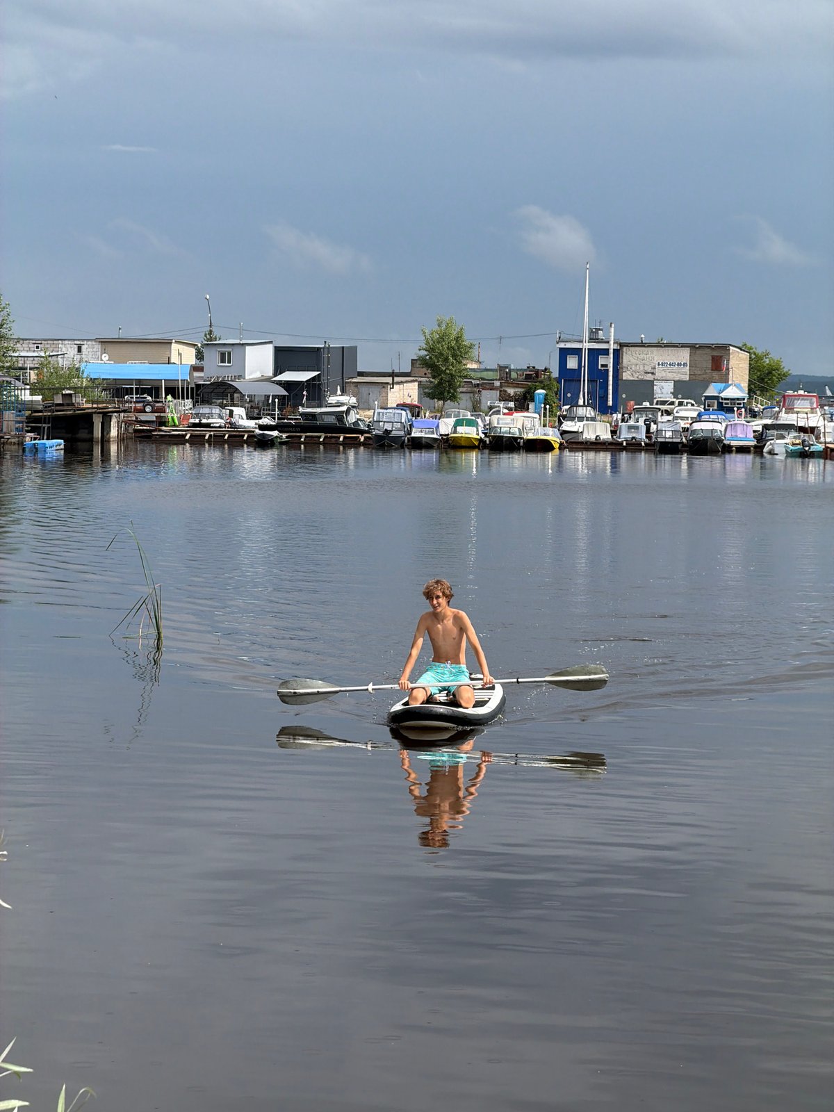 Paddleboarding on calm marina water in Chaikovsky, Russia