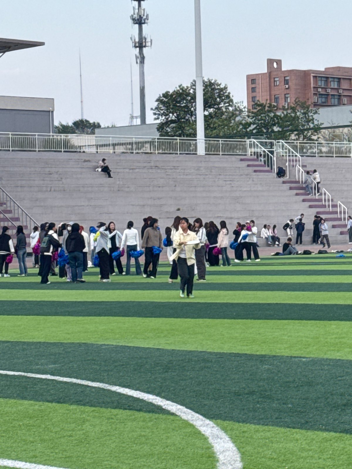 Group gathers at Linghe stadium, women observe sky