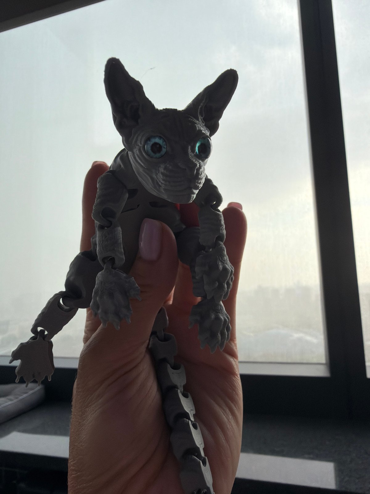 Moscow resident documents articulated sphynx cat toy in building lobby