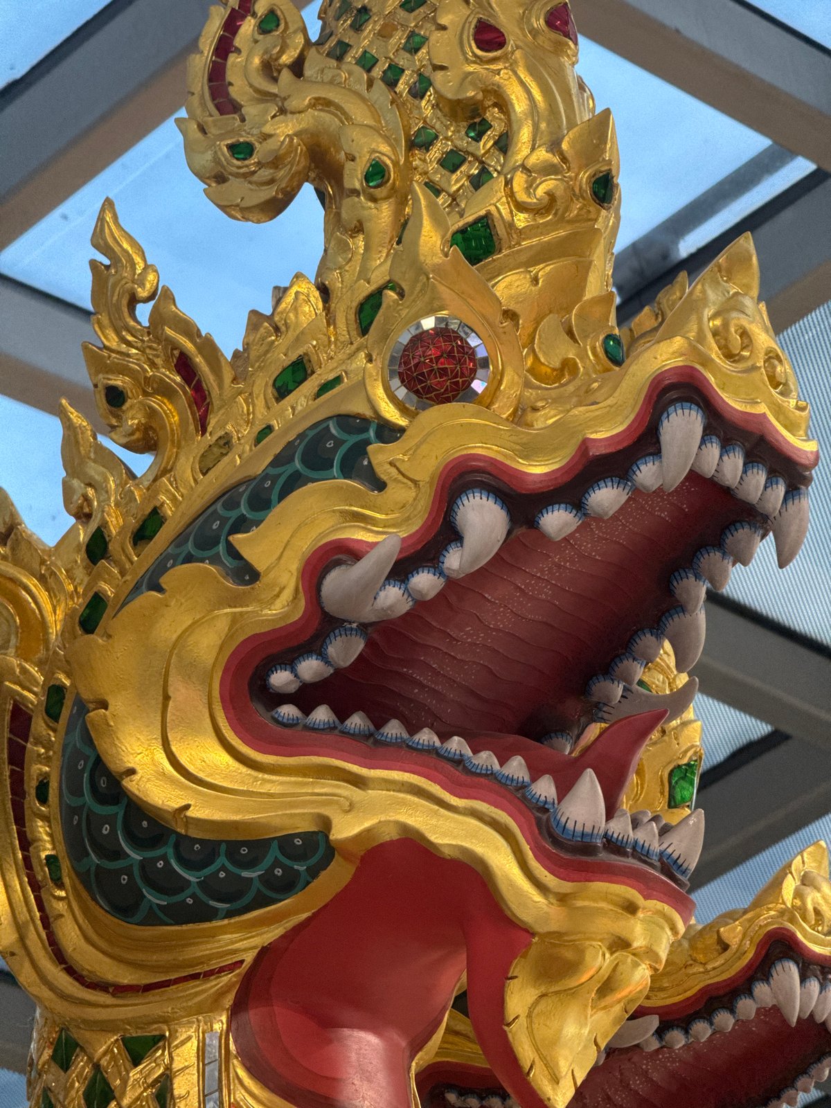 Luxury storefronts and mythological sculptures at Suvarnabhumi Airport