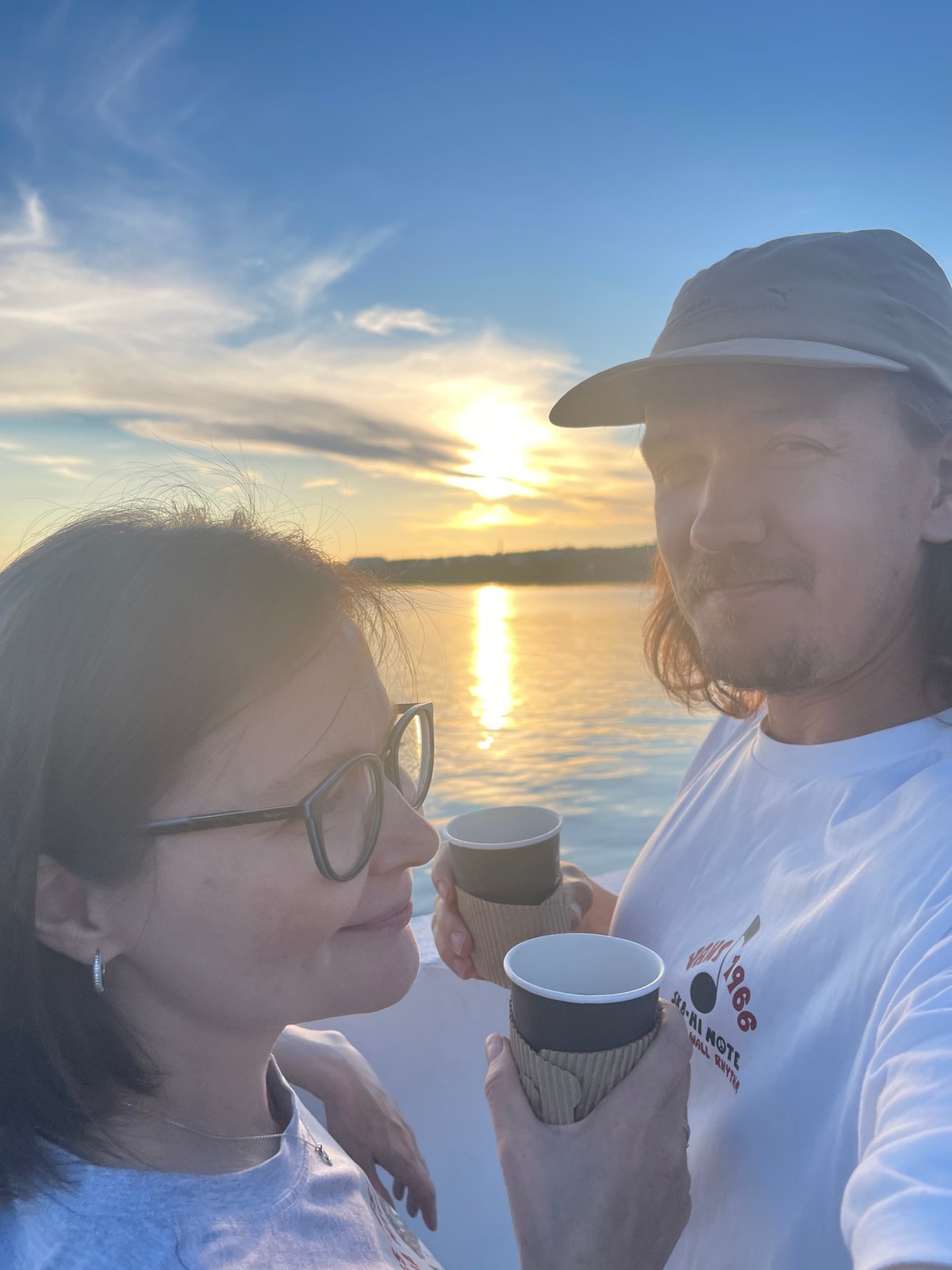 Urban waterfront sunset draws couples, boaters, coffee drinkers