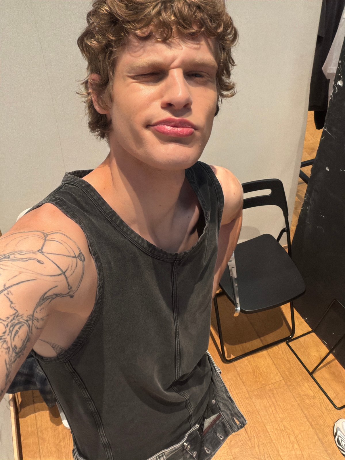 Person with blonde hair and tattoo photographed Thursday morning