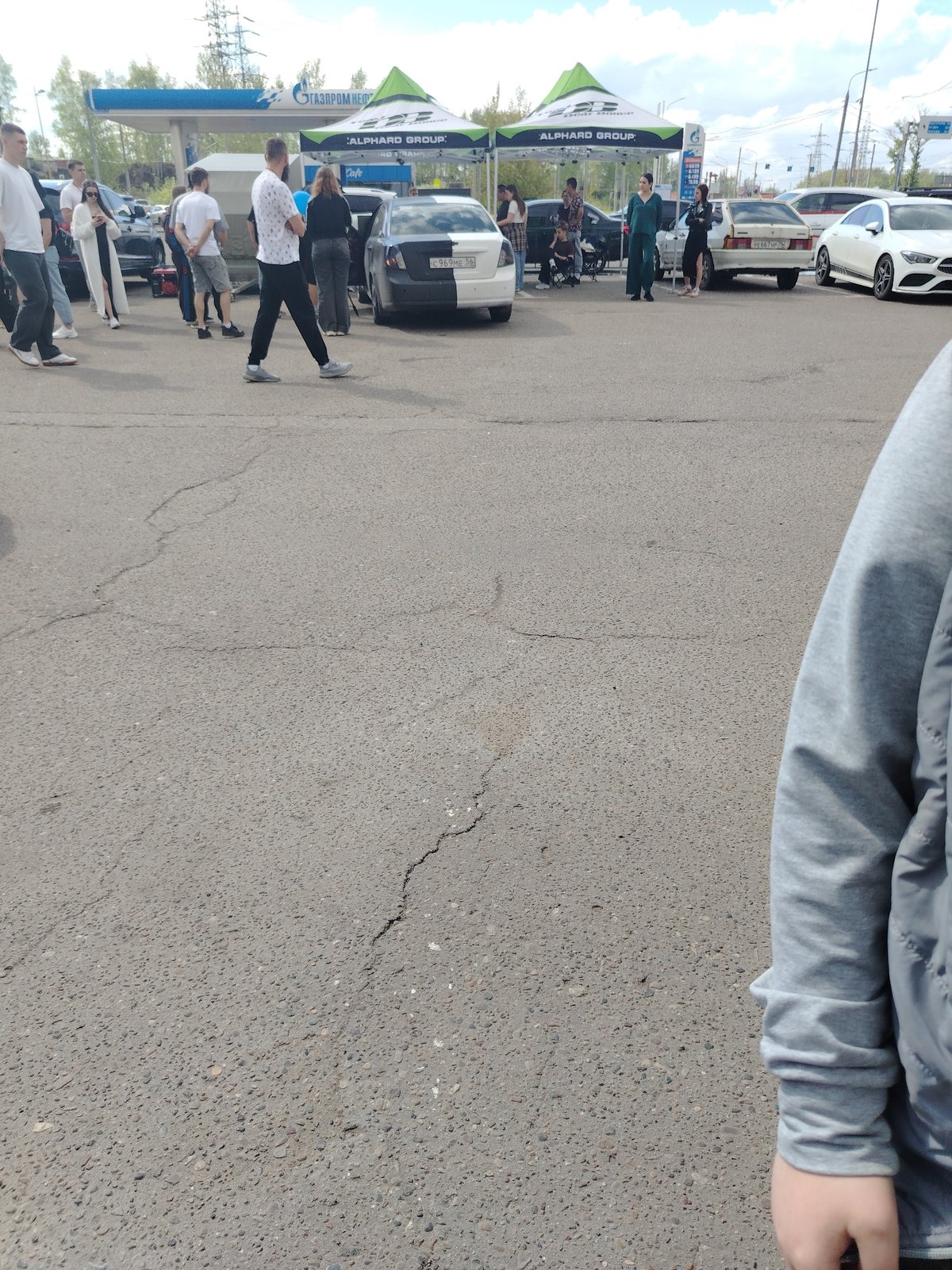 People gather in parking lot in Шебунино, Russia