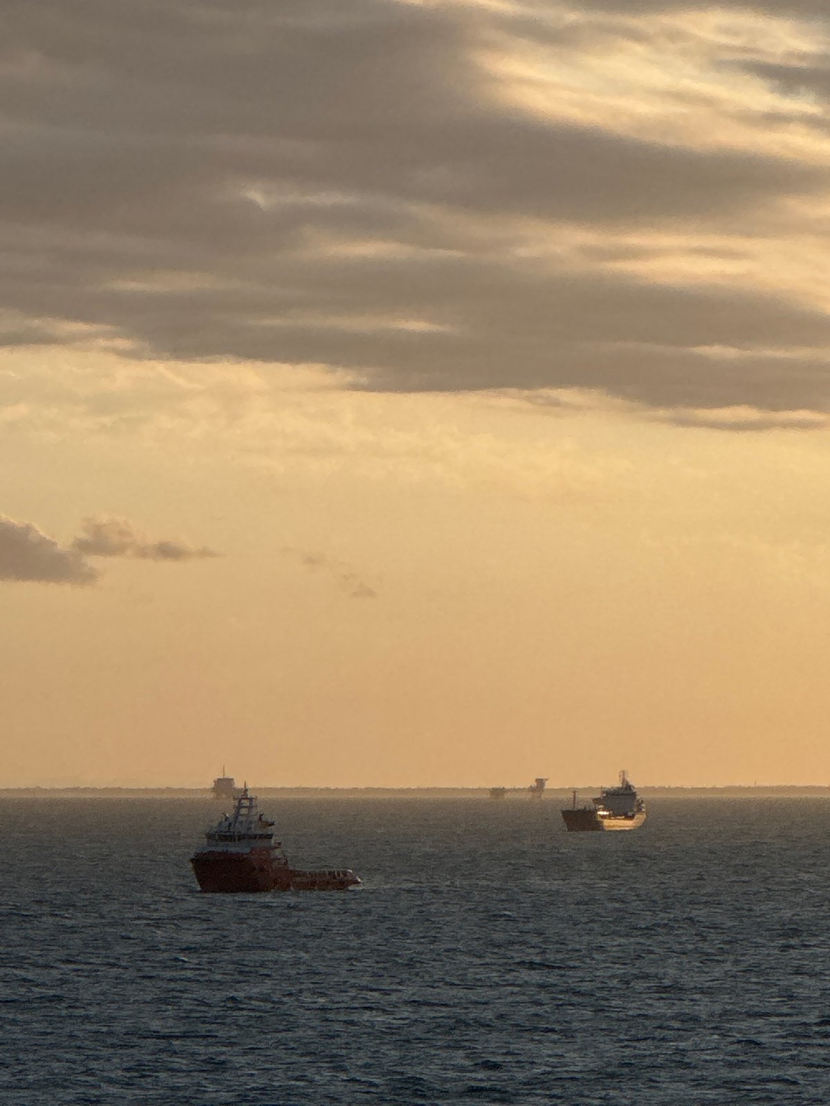 Offshore platform operations documented during sunset in Adriatic Sea