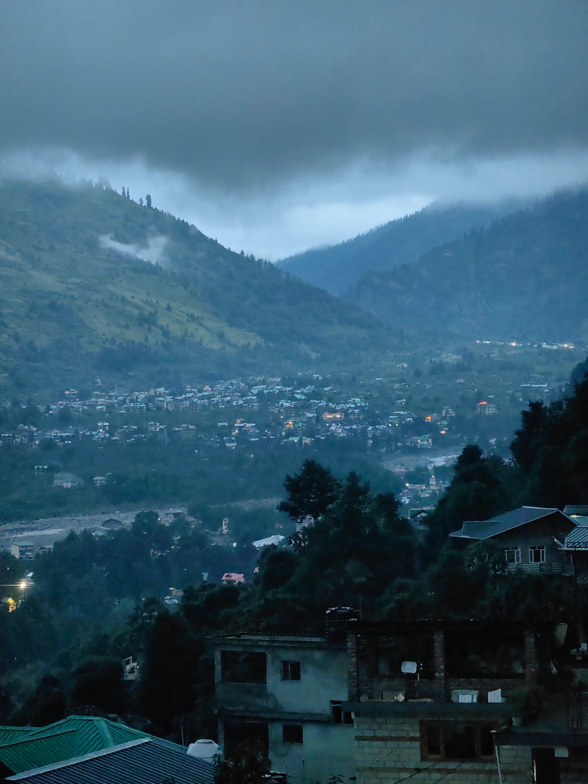 Foggy dusk settles over the hillside town of Vashisht