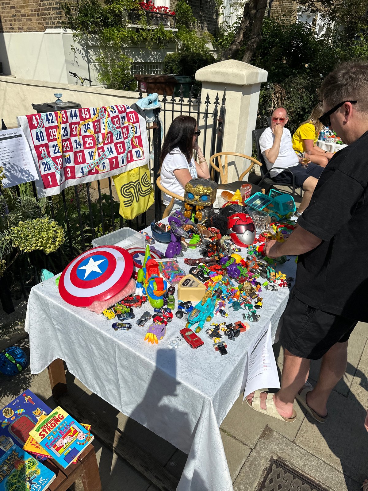 Neighborhood jumble sale held on London residential street