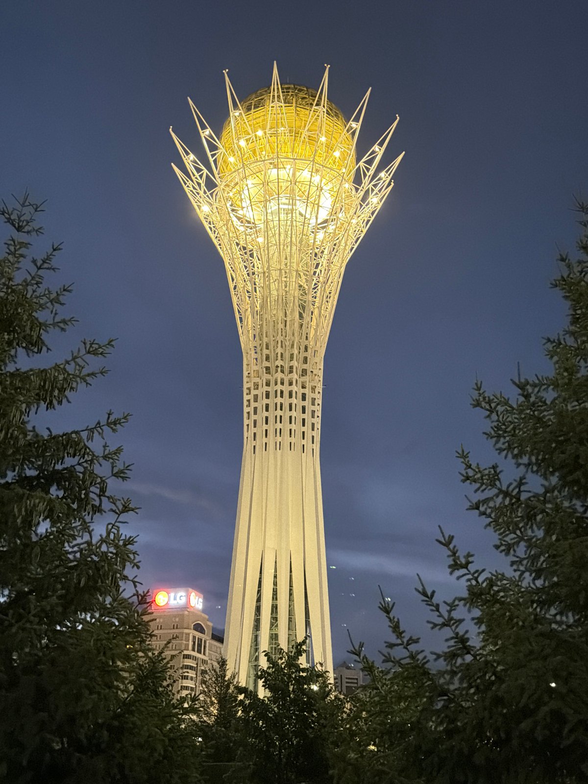 Bayterek Tower and Astana skyline glowing after dark