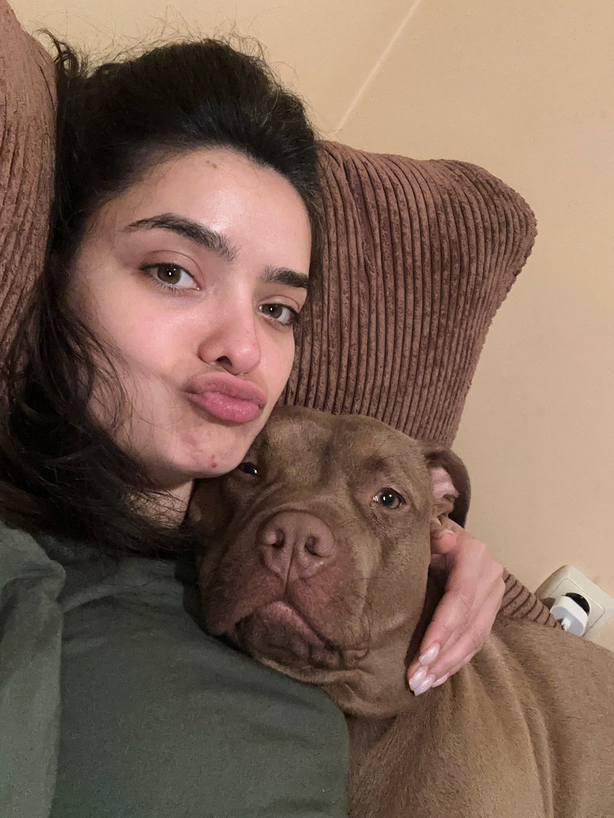 Couch selfies with a brown pit bull in Malevo