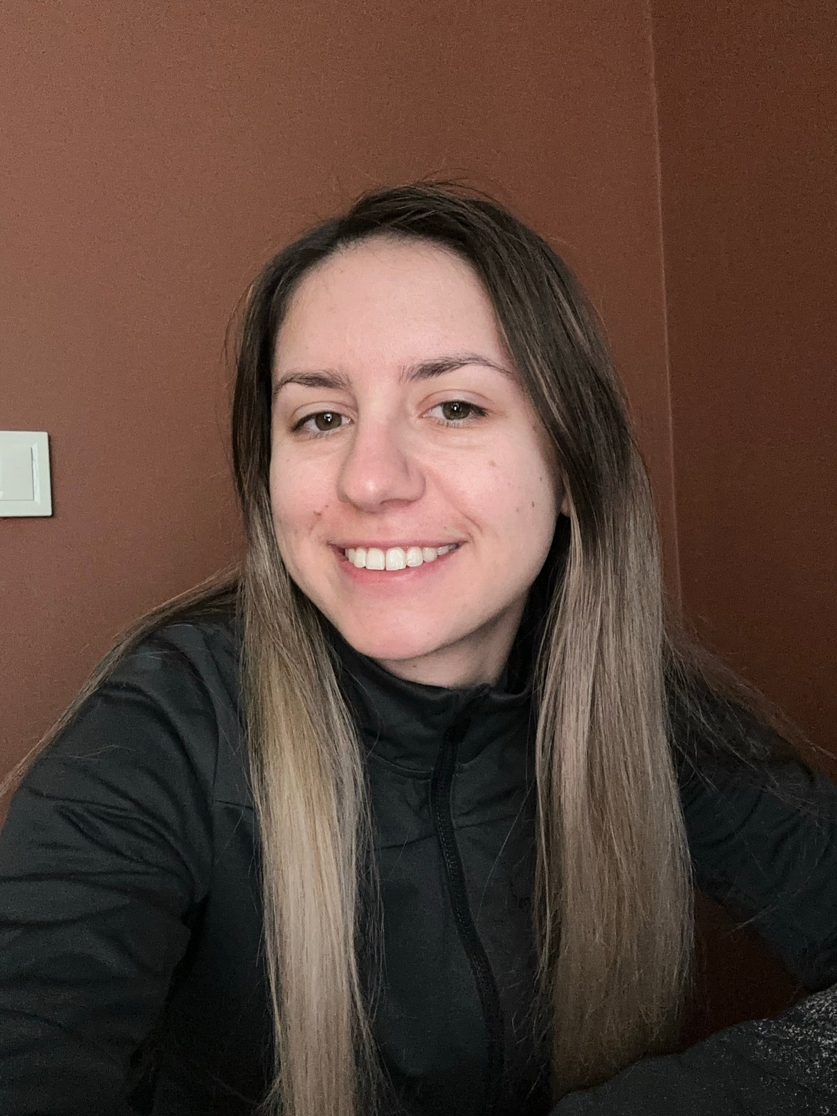 Woman photographed smiling indoors in Sofia, Bulgaria