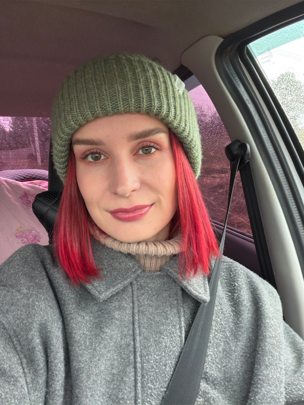 Red-haired person takes selfie in car in Chaikovsky