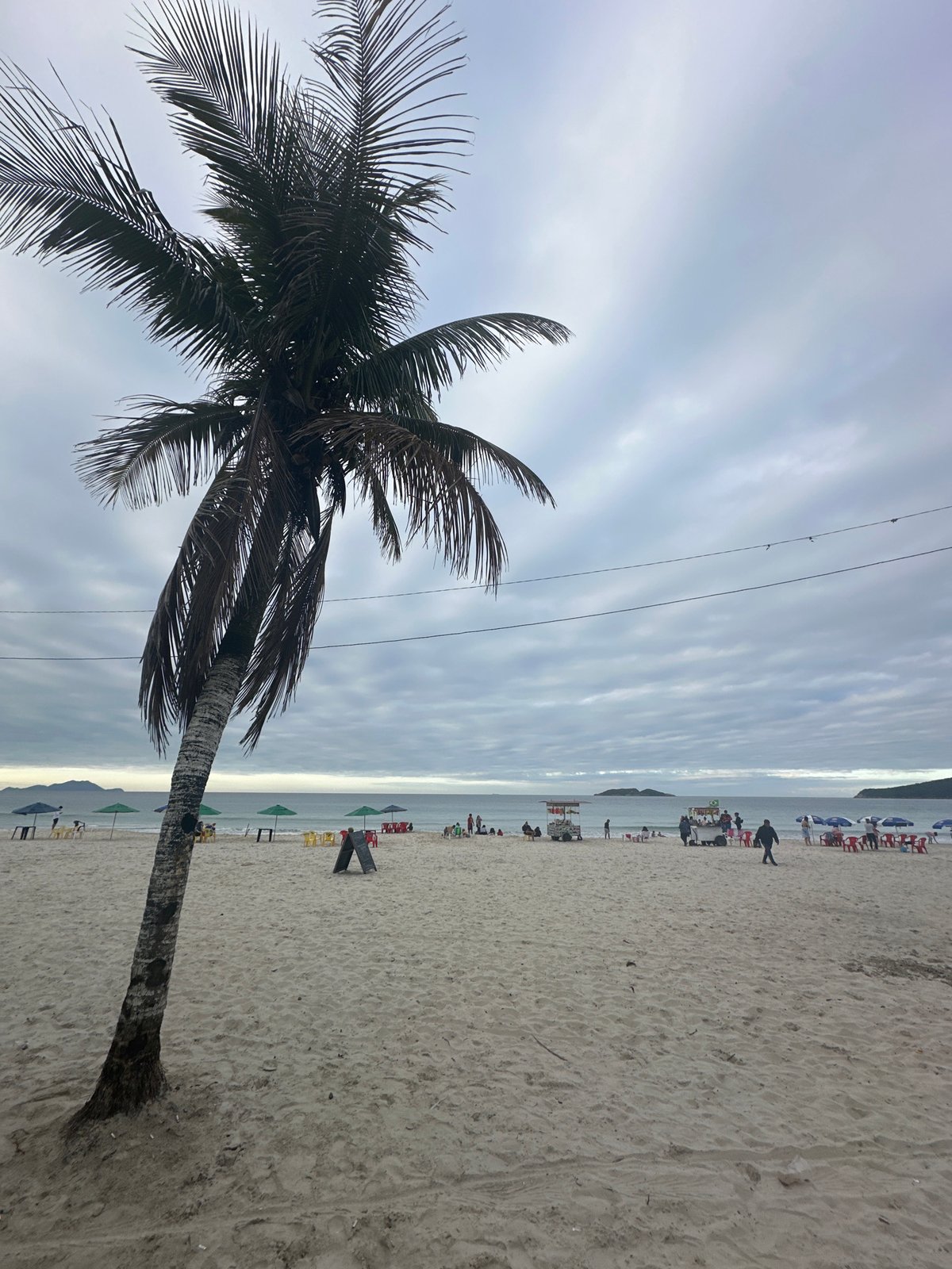 Quiet beach vendor scene on a cloudy day in Florianópolis