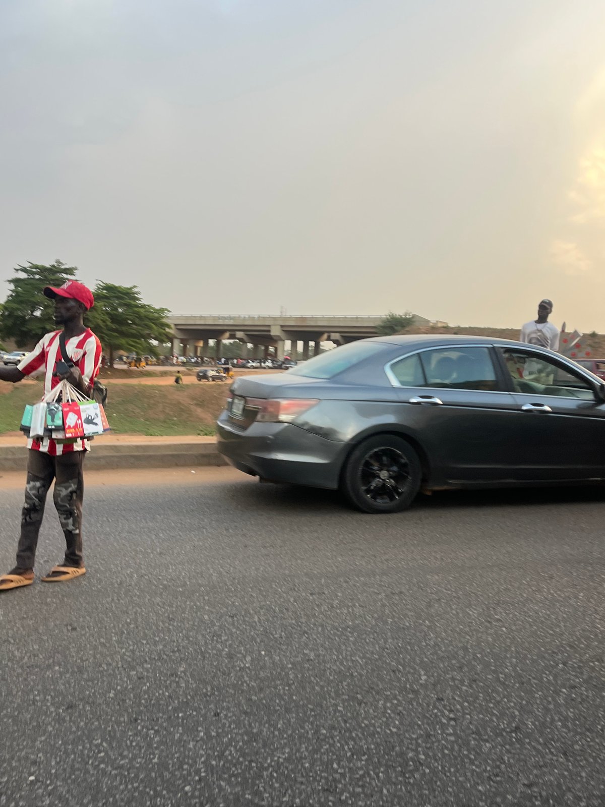 Street vendor sells items roadside near Galadimawa Village, Nigeria
