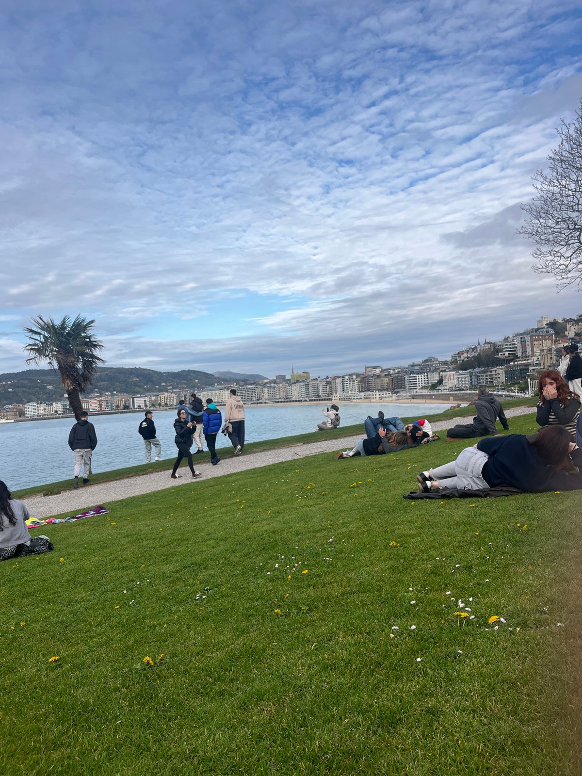 Woman enjoys afternoon rest on San Sebastián coastal grass