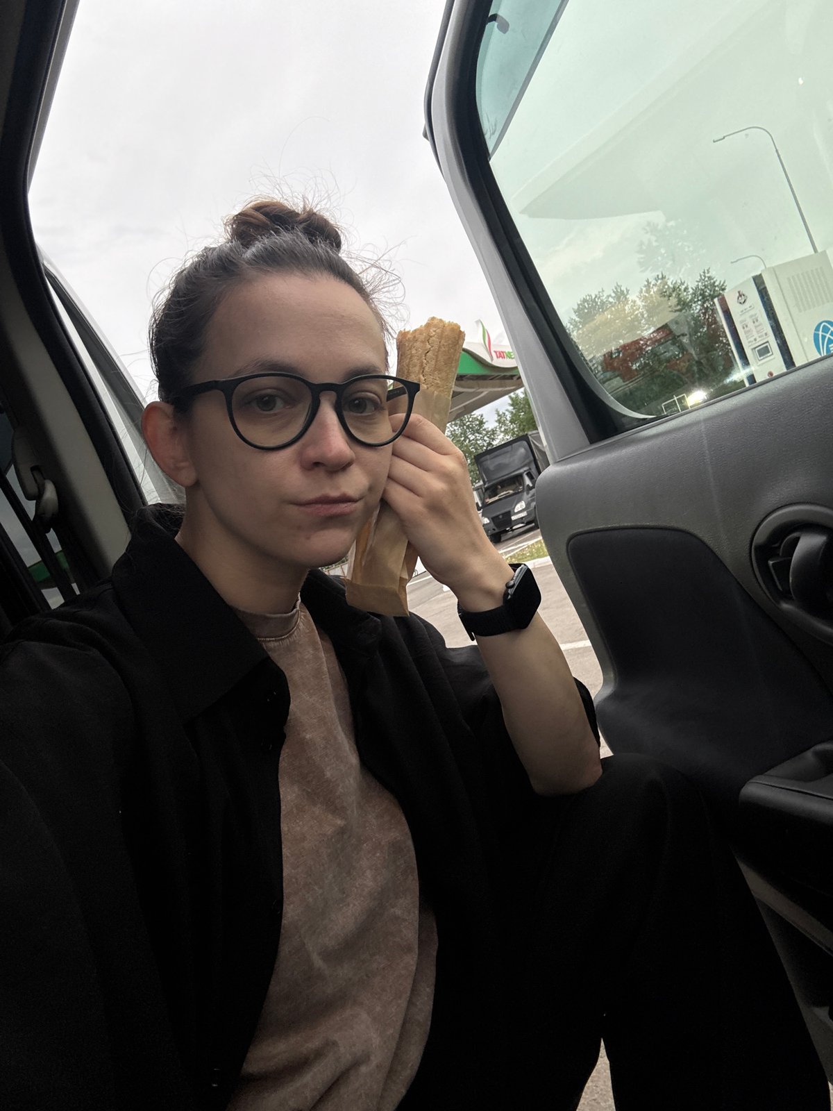 Person enjoys roadside meal at Russian gas station