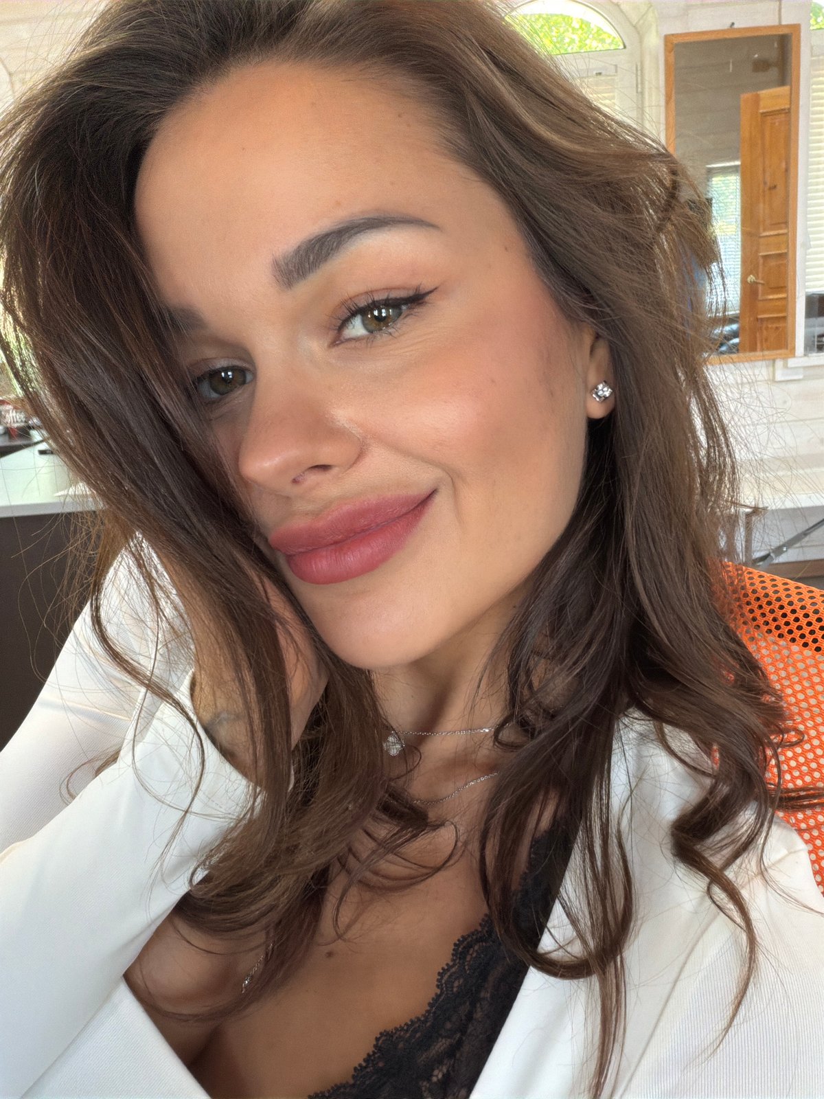 Woman takes selfies indoors in Saint Petersburg