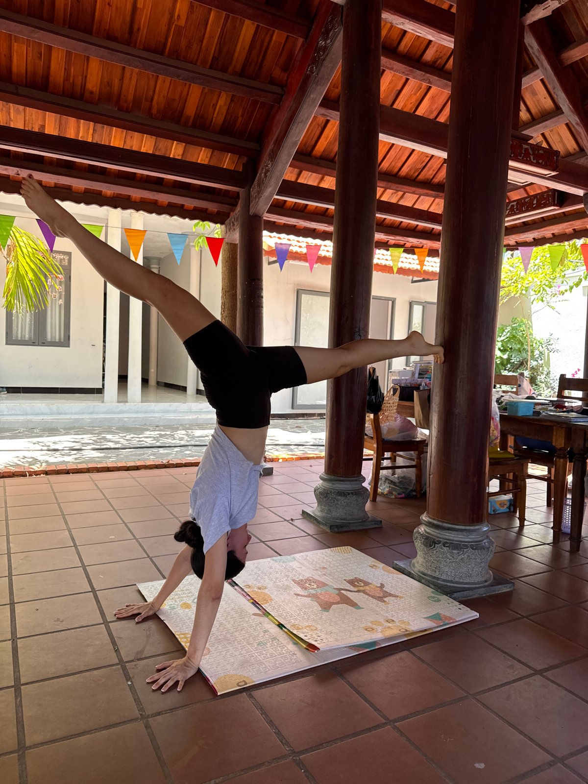 Woman performs early morning gymnastics routine in Mũi Né pavilion