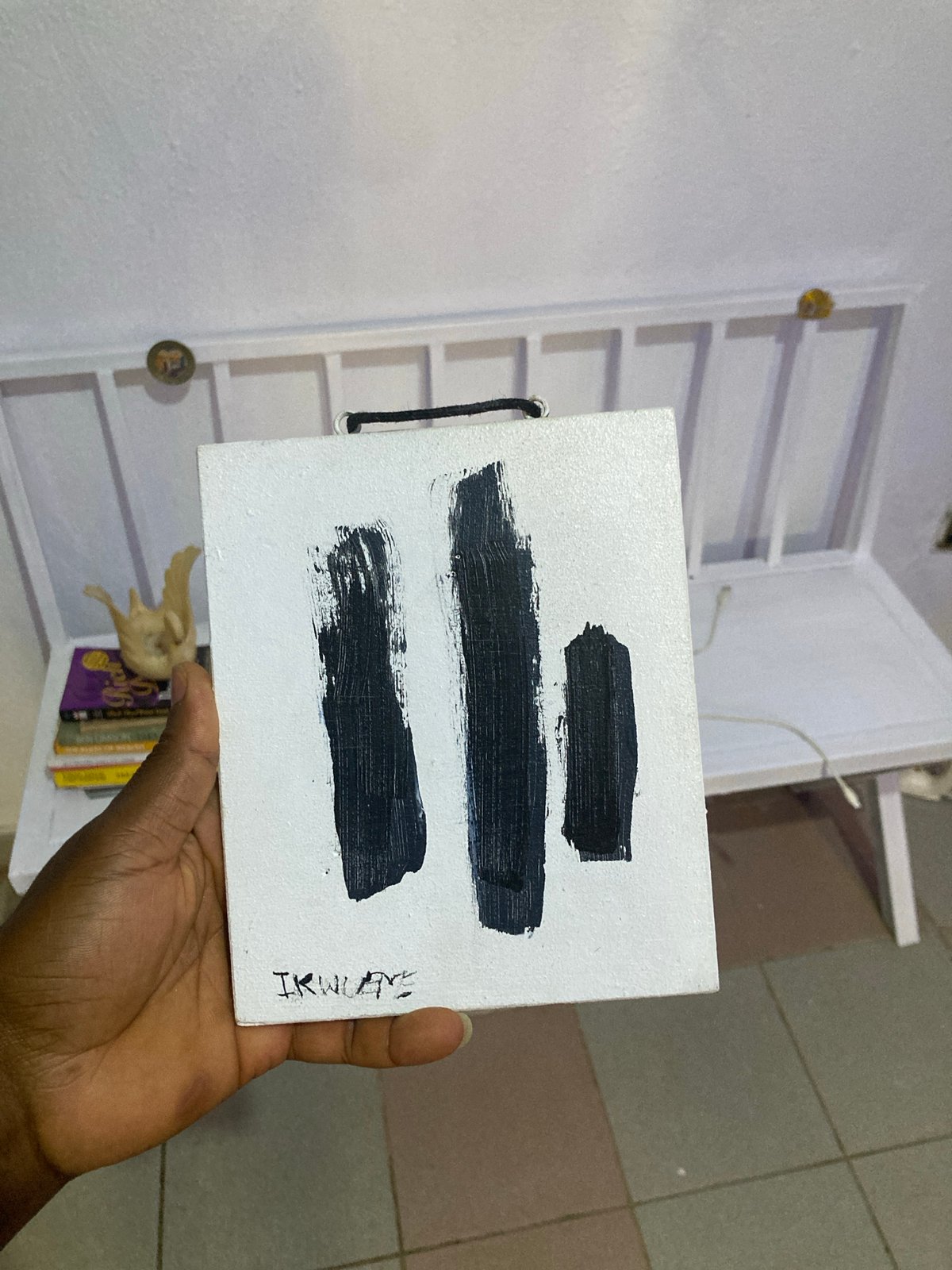 Artist Ikwuoye displays signed canvas during morning in Jos