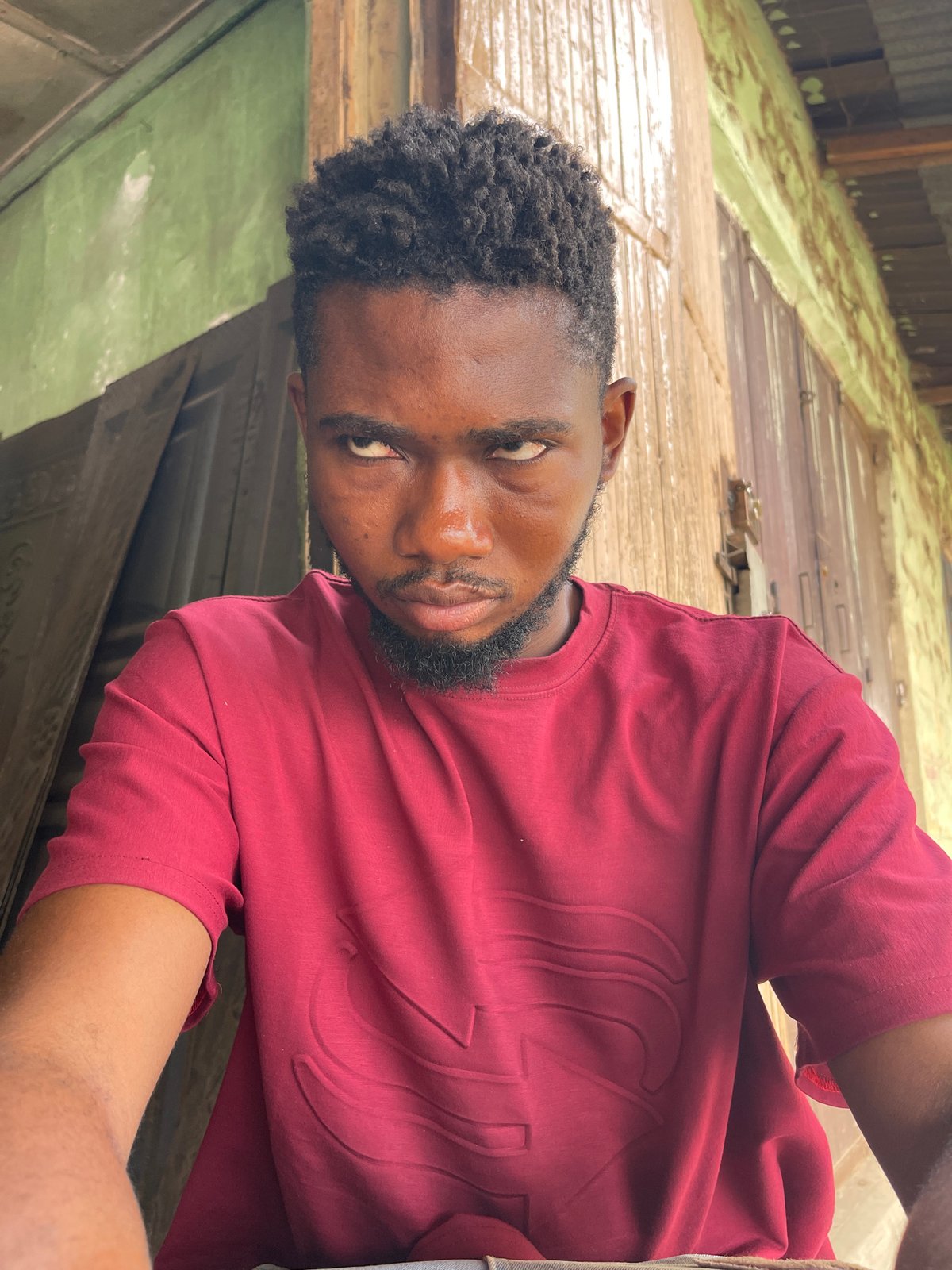Two men photographed in outdoor Zaria locations within minutes