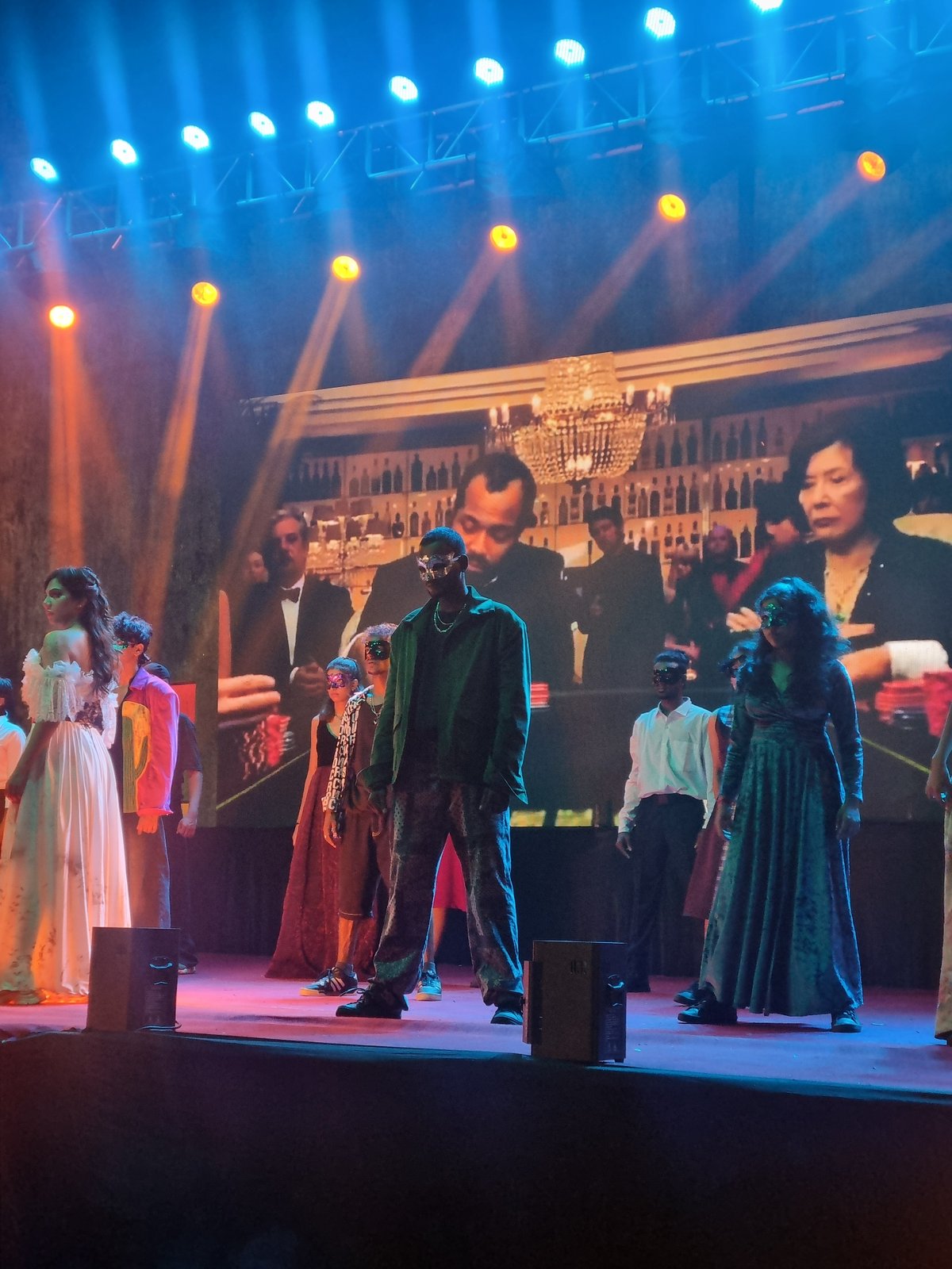 Live theatrical performance features dramatic blue stage lighting