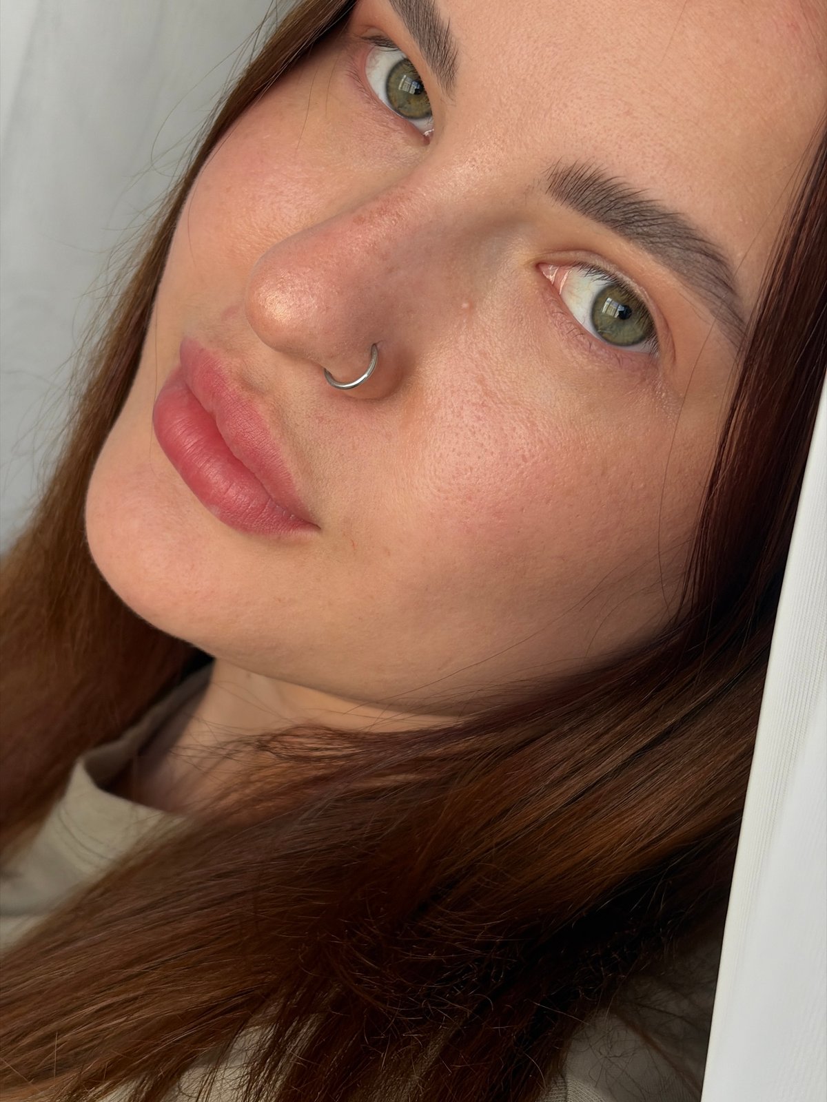Close-up portraits of woman with nose ring captured indoors