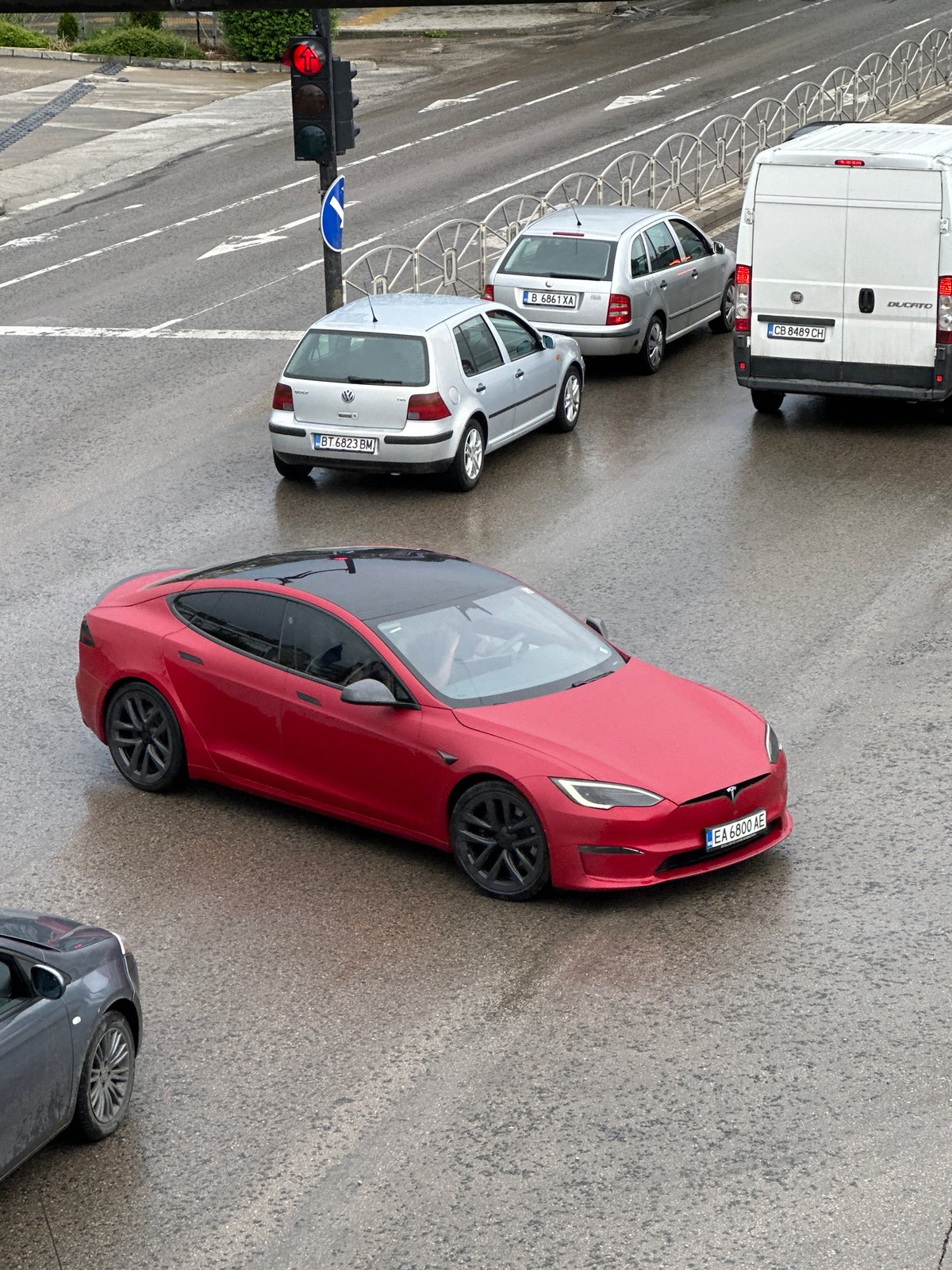 Wet street traffic observed in Veliko Tarnovo during overcast conditions