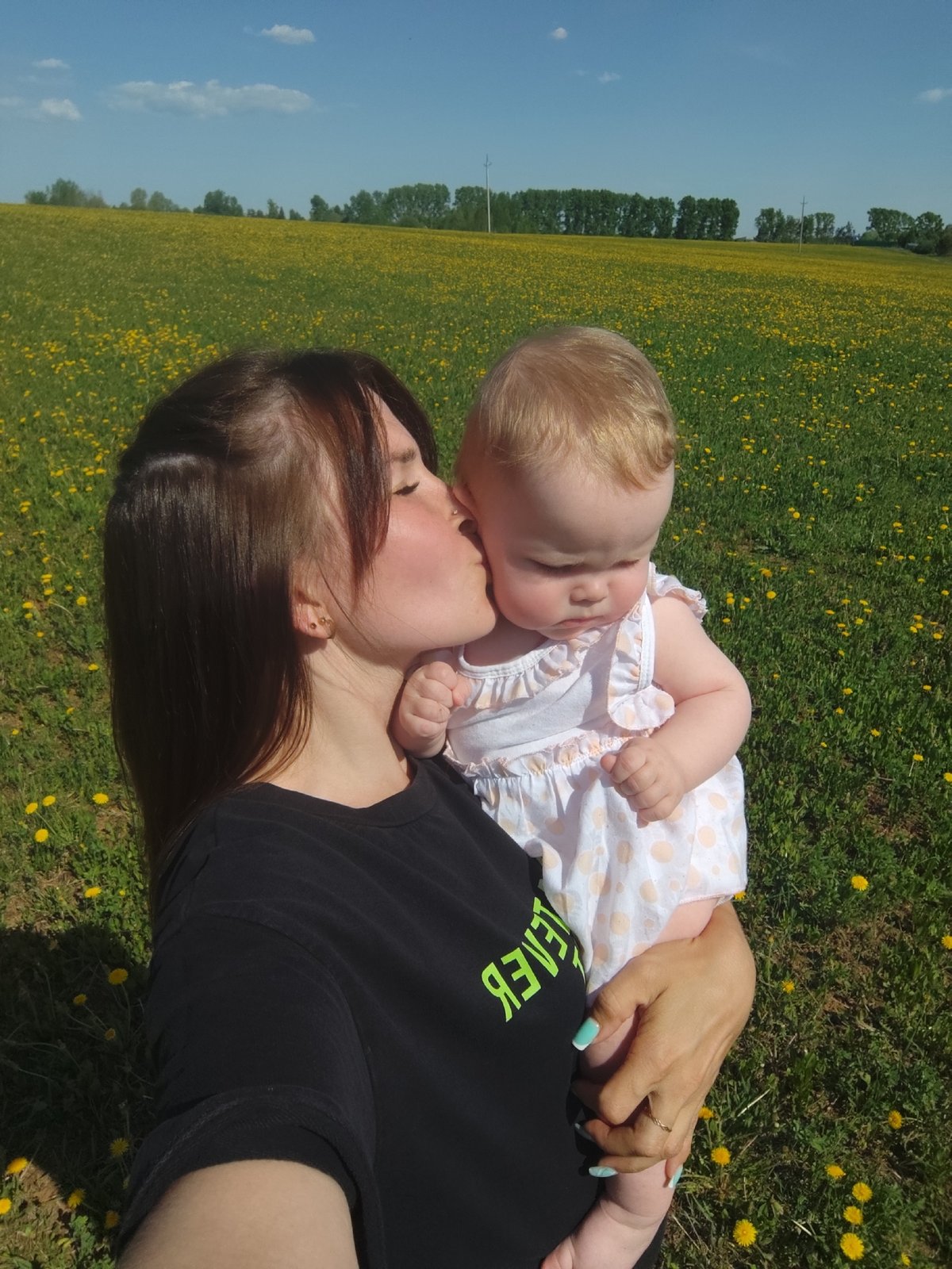 Mother and baby share tender moments in Russian flower field