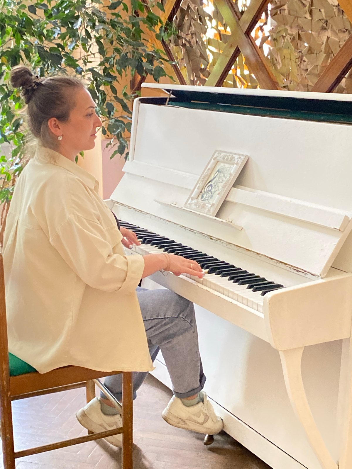 Woman plays piano, takes selfie in Марковский, Russia