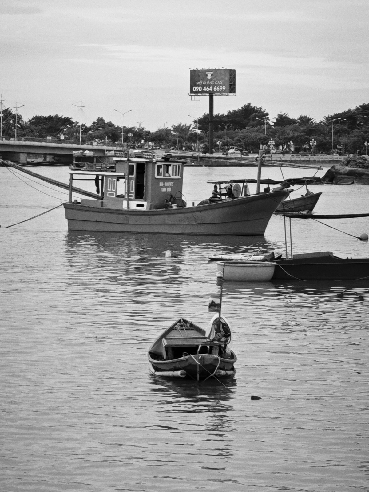 Cai River harbor life, Nha Trang — boats and bridges