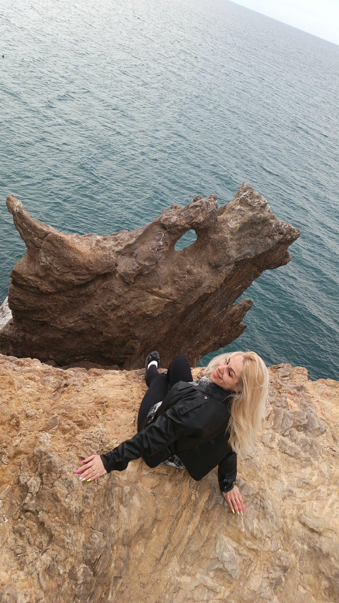 Tourists explore scenic Balaklava cliffs, pose with souvenir mugs