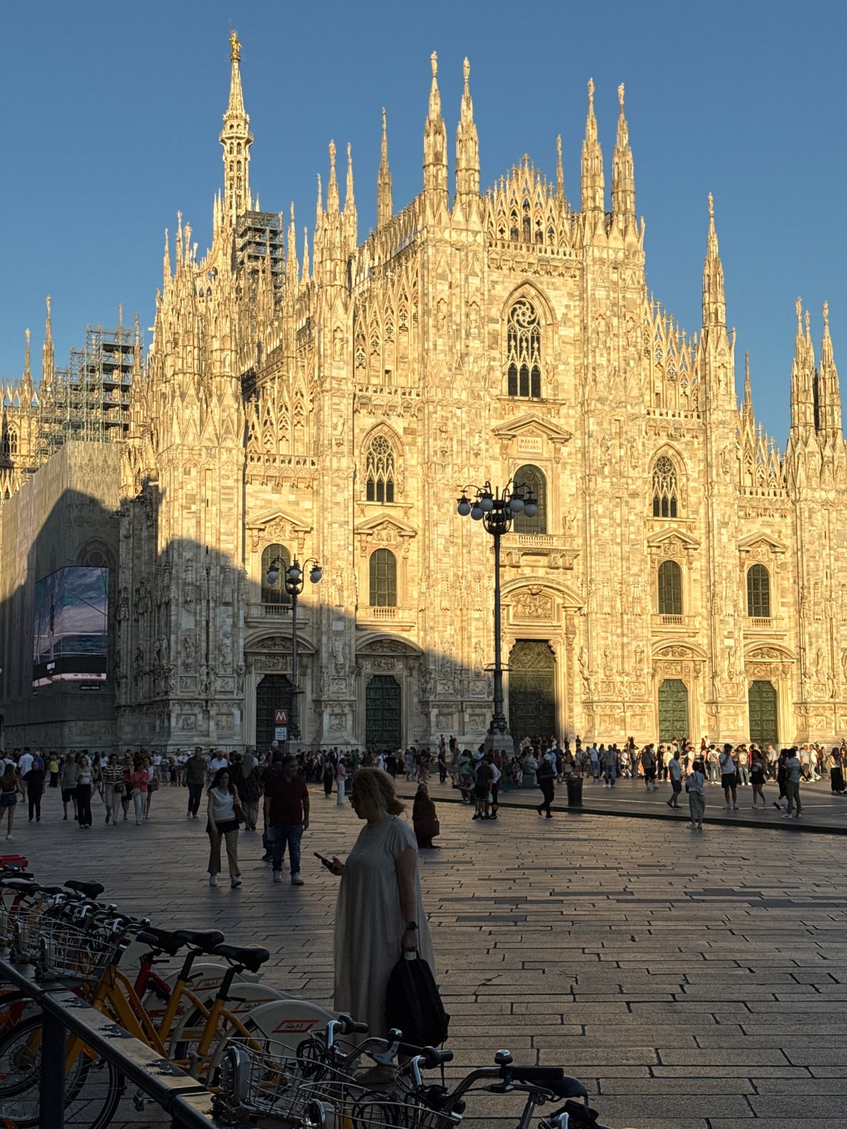 Duomo di Milano at golden hour, crowds and cobblestones