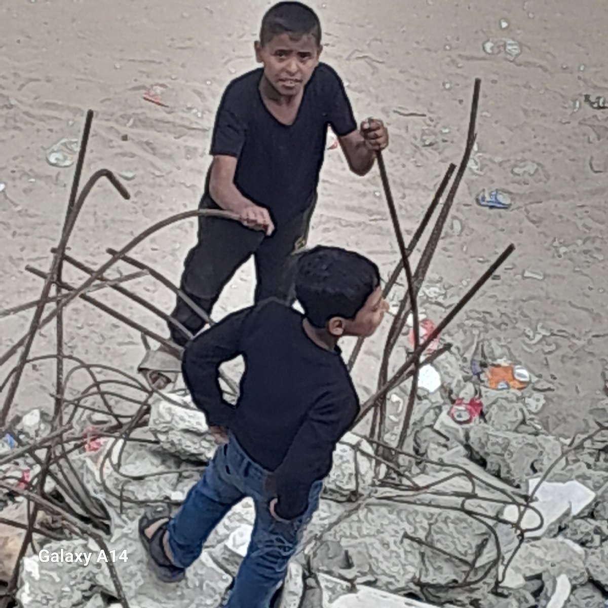 People navigate debris field amid twisted metal, rubble