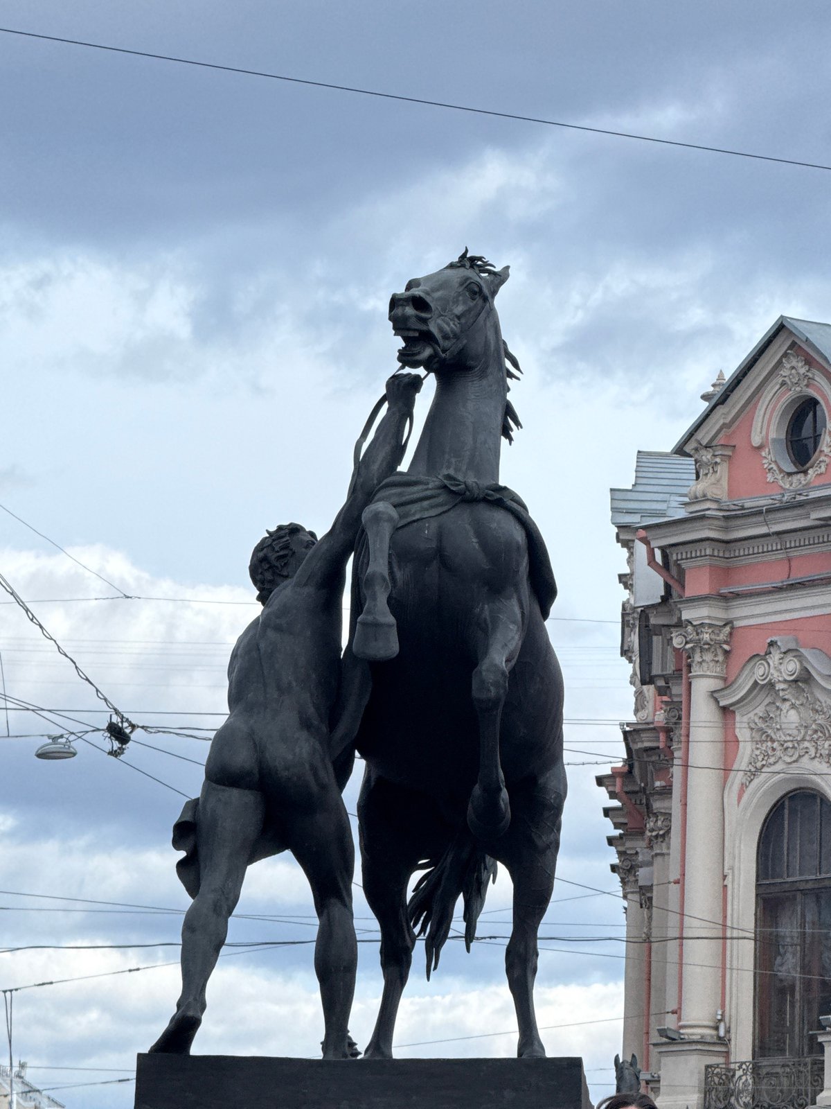 Equestrian statue photographed against cloudy sky in Saint Petersburg