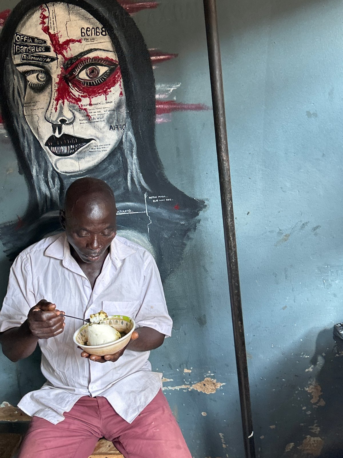 Street scenes outside a mural in Jos, Nigeria