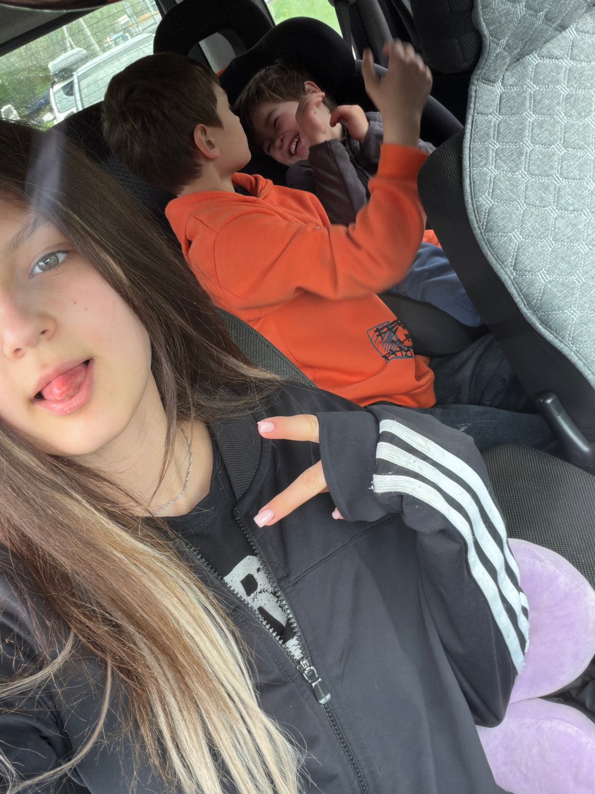 Woman takes selfie in car interior