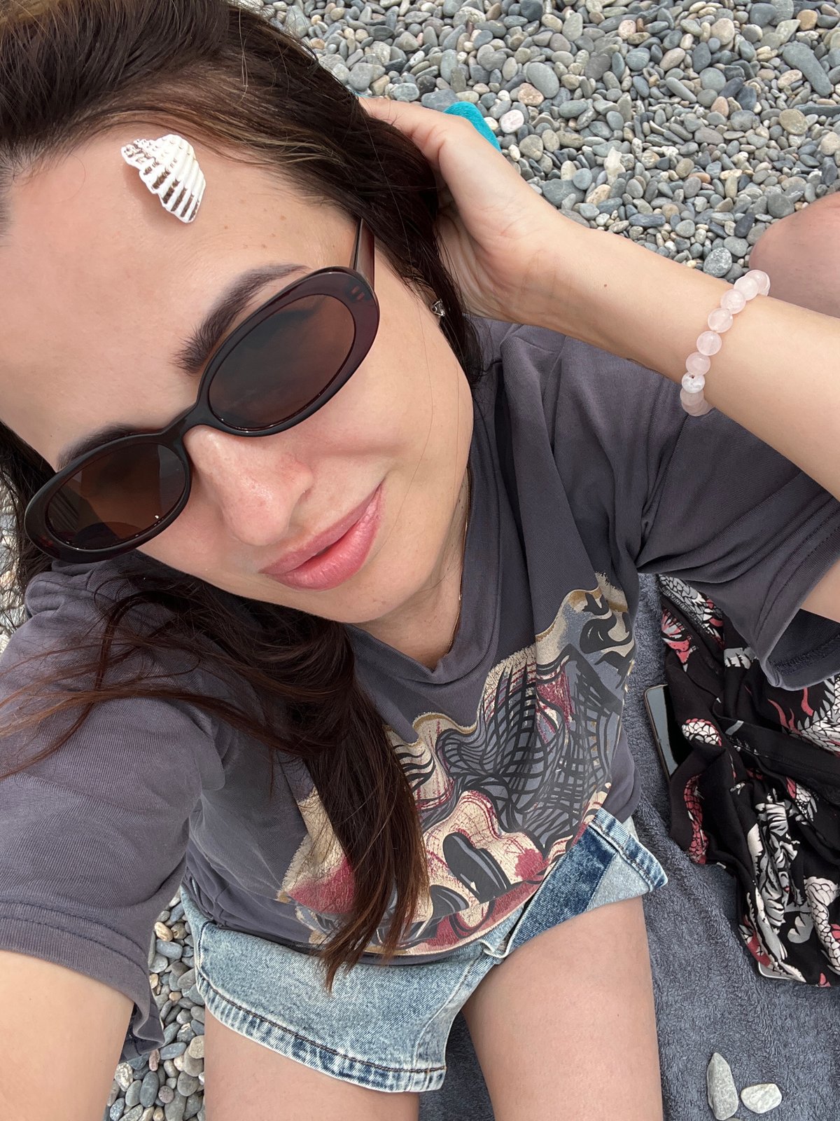 Beach day selfies and relaxation on pebble shore