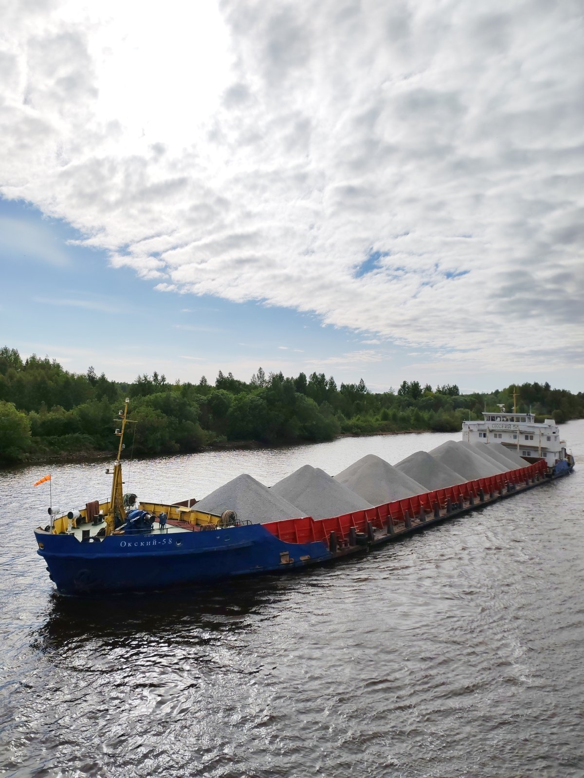 Cargo barges transit Volga-Baltic Waterway near Vytegra, Russia