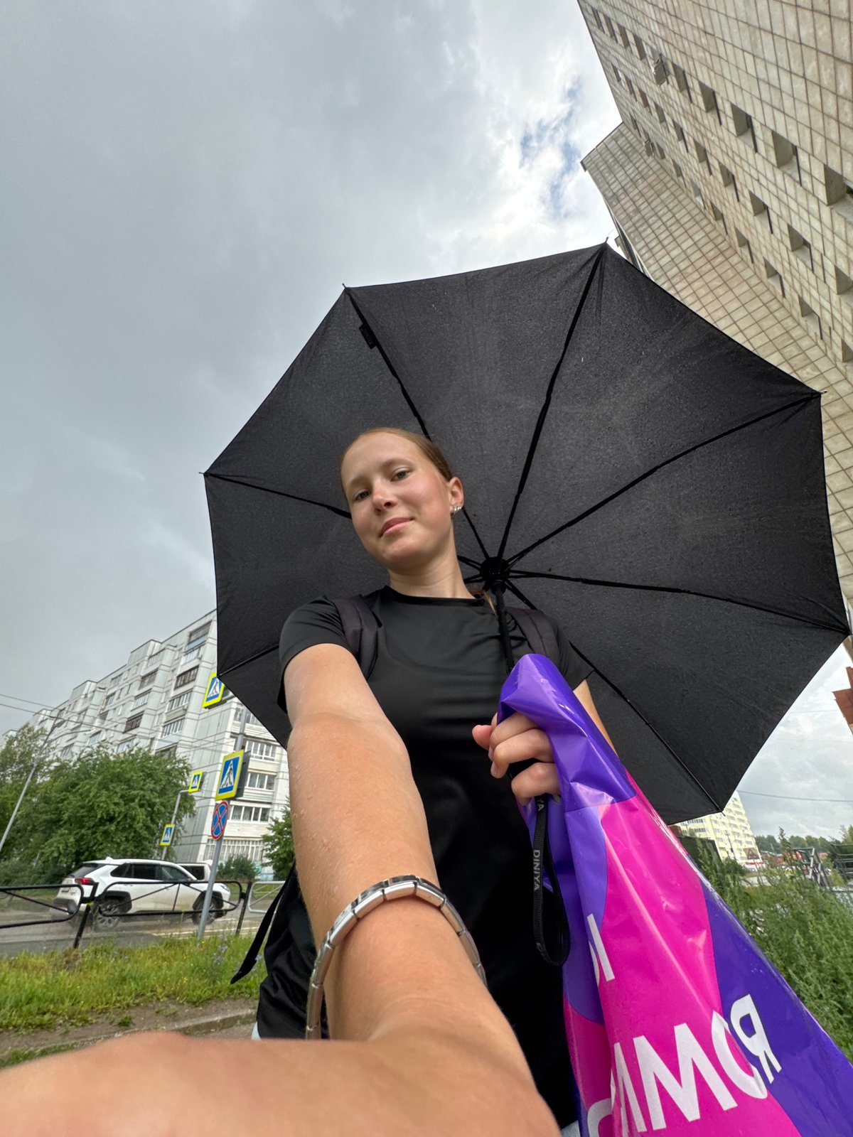Rainy day in Chaikovsky featuring a heterochromic black cat