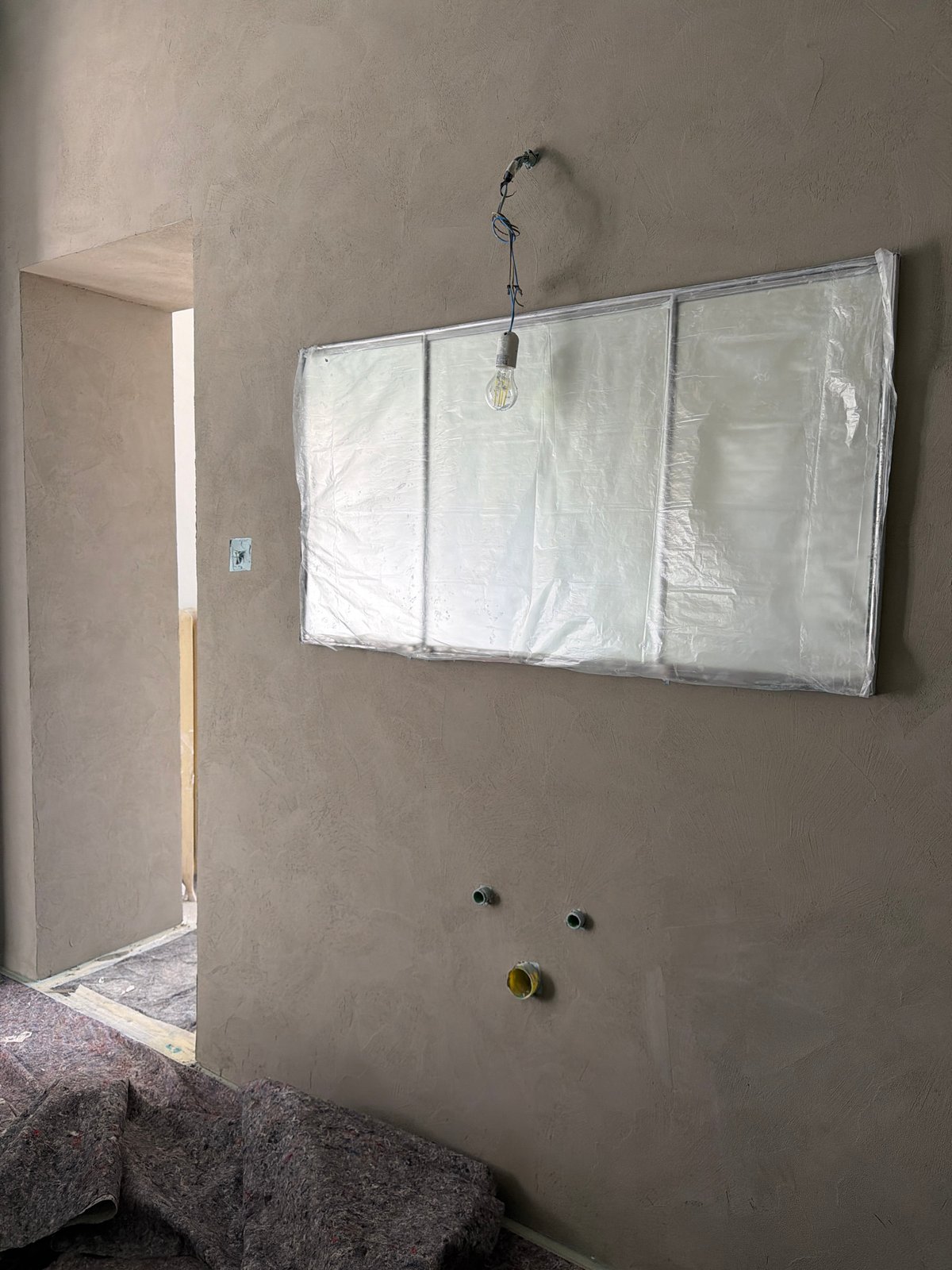 Ceiling construction with skylight installation underway in Erba, Italy