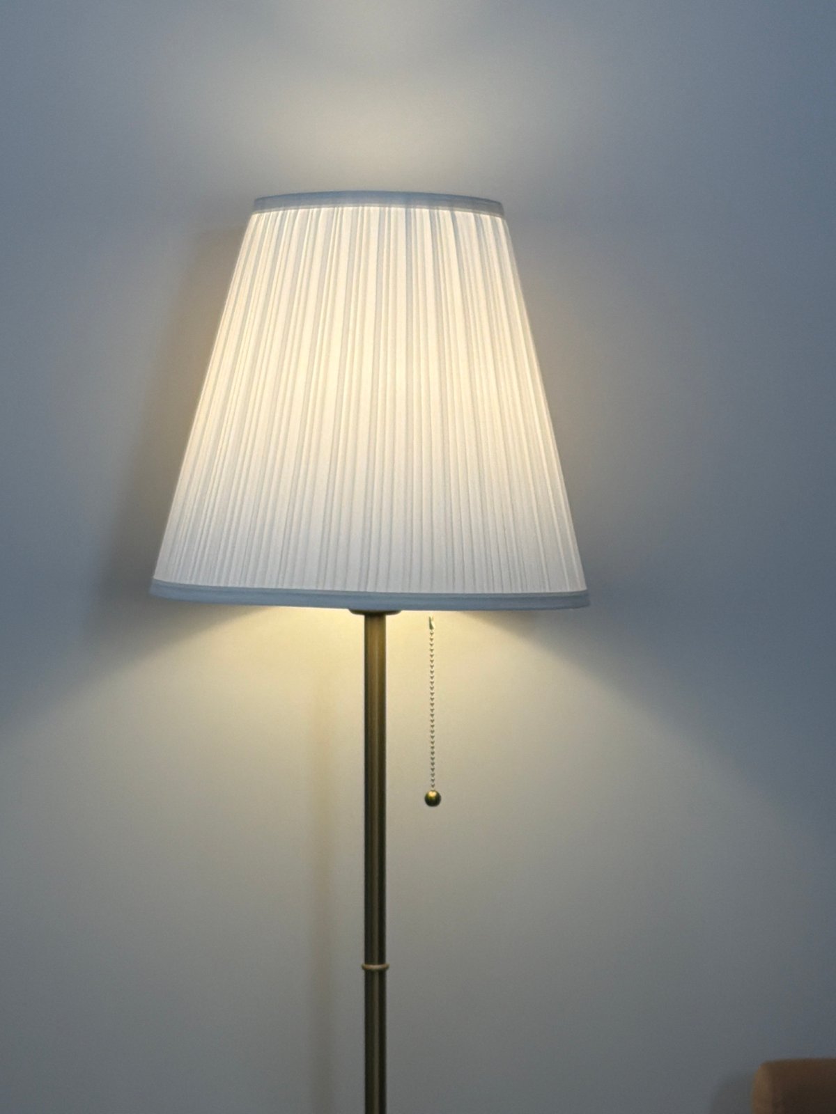 Wall lamp with white pleated shade documented in Moscow