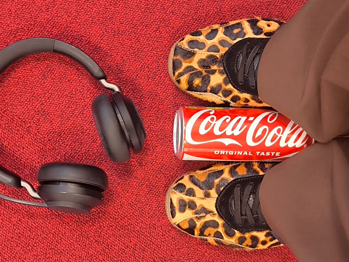 Riga resident documents casual desk snack moment with headphones