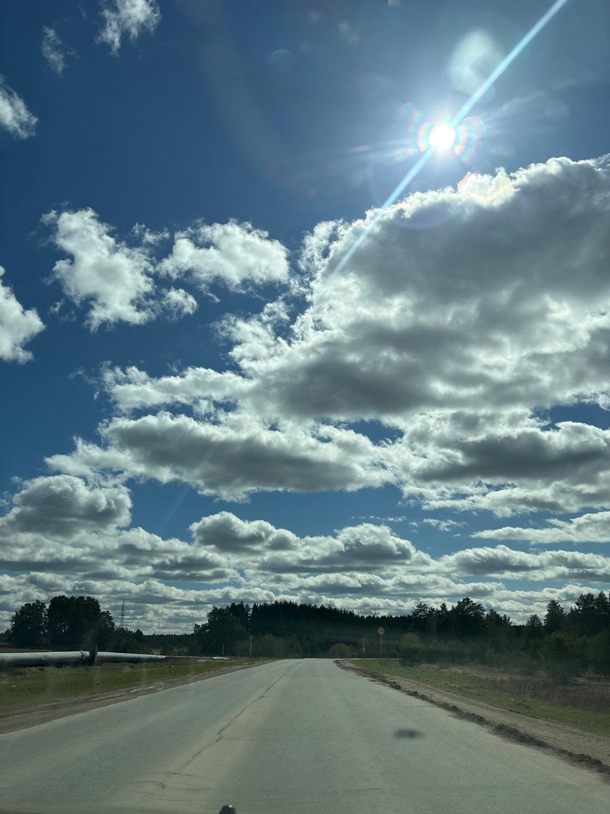 Clear skies documented along rural road in Прикамский, Russia