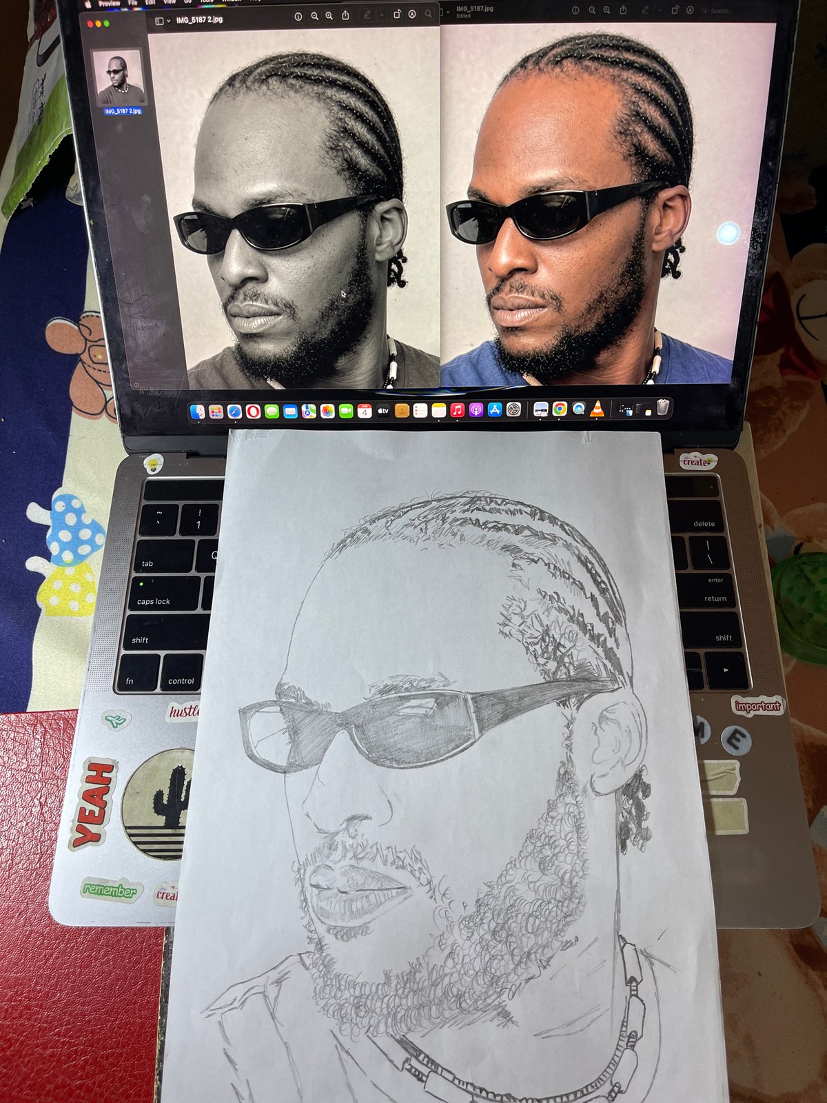 Artist sketches detailed portrait from laptop reference in Jos