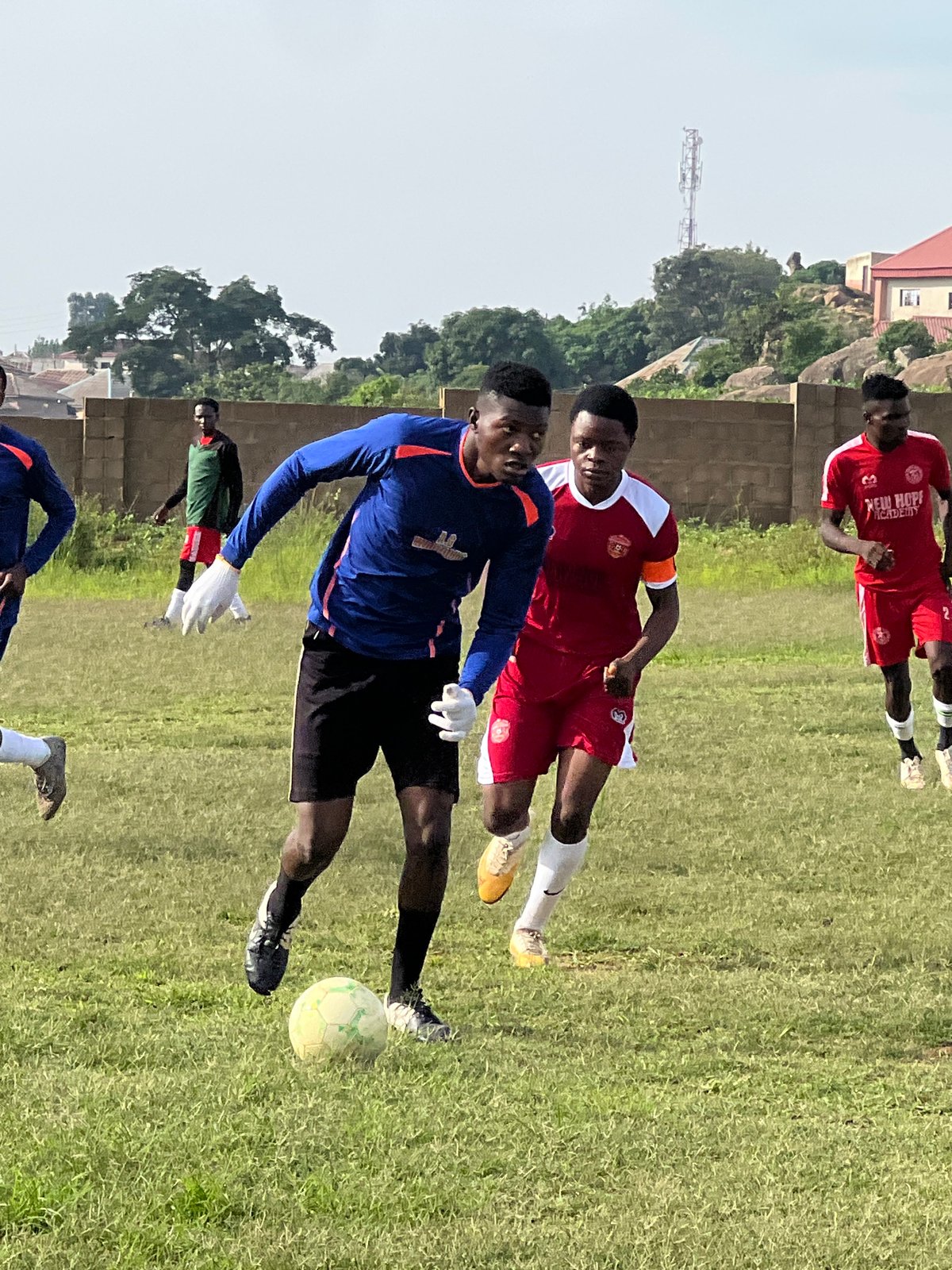 Pickup soccer match on a patchy field in Jos, Nigeria.