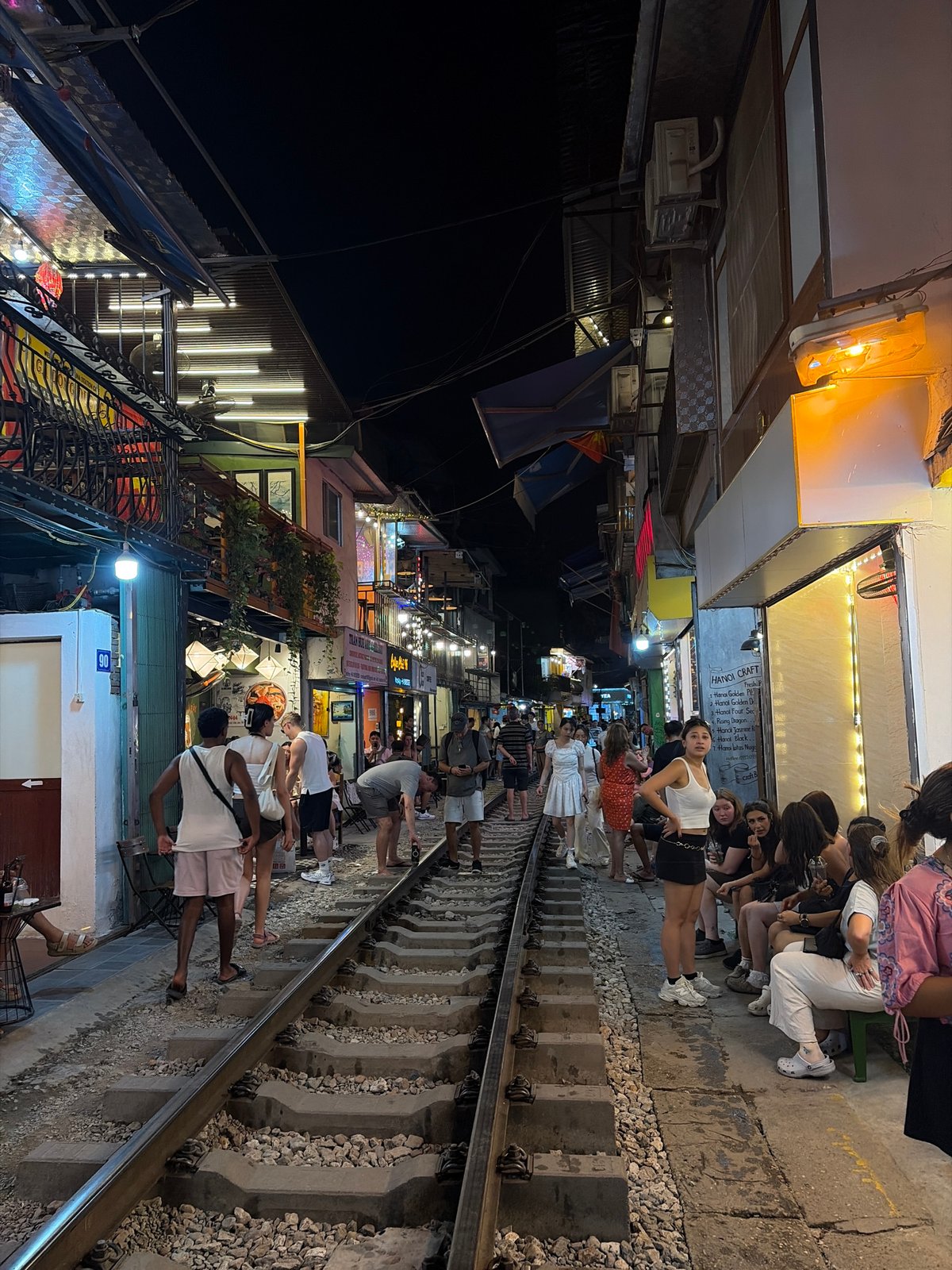 Train passes through Hanoi's Train Street cafes at night
