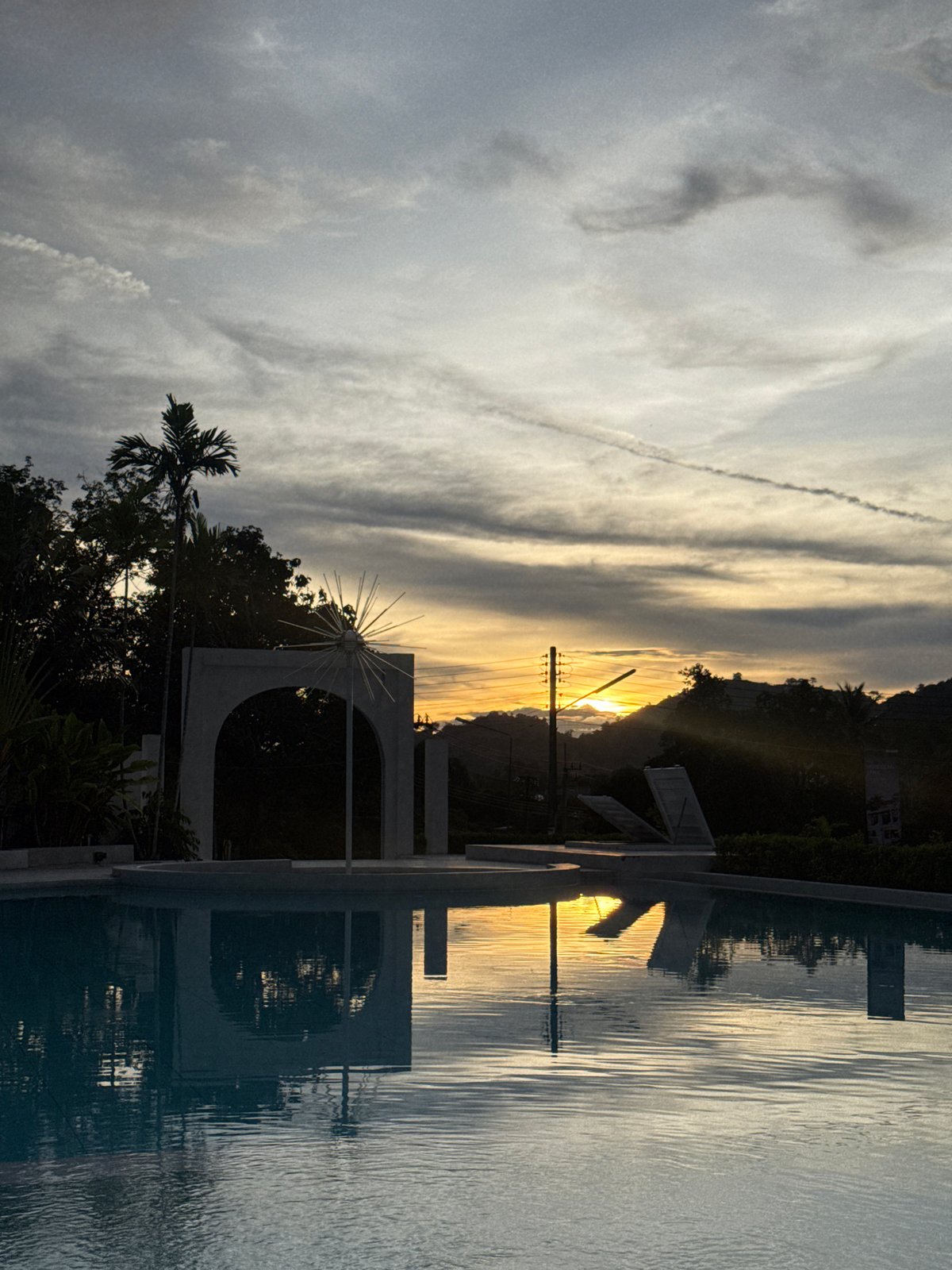 Sunset reflection captured near ornamental structure in Pa Khlok