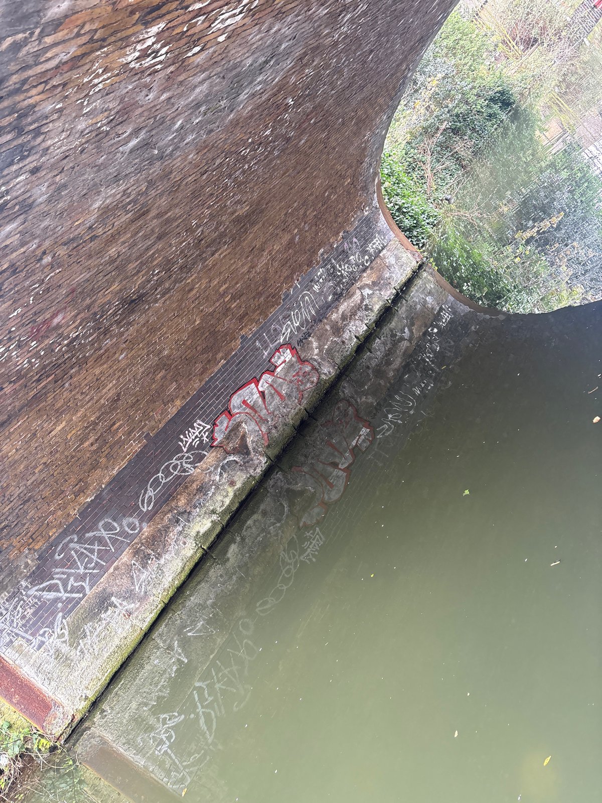 London canal bridge with graffiti documented by witness