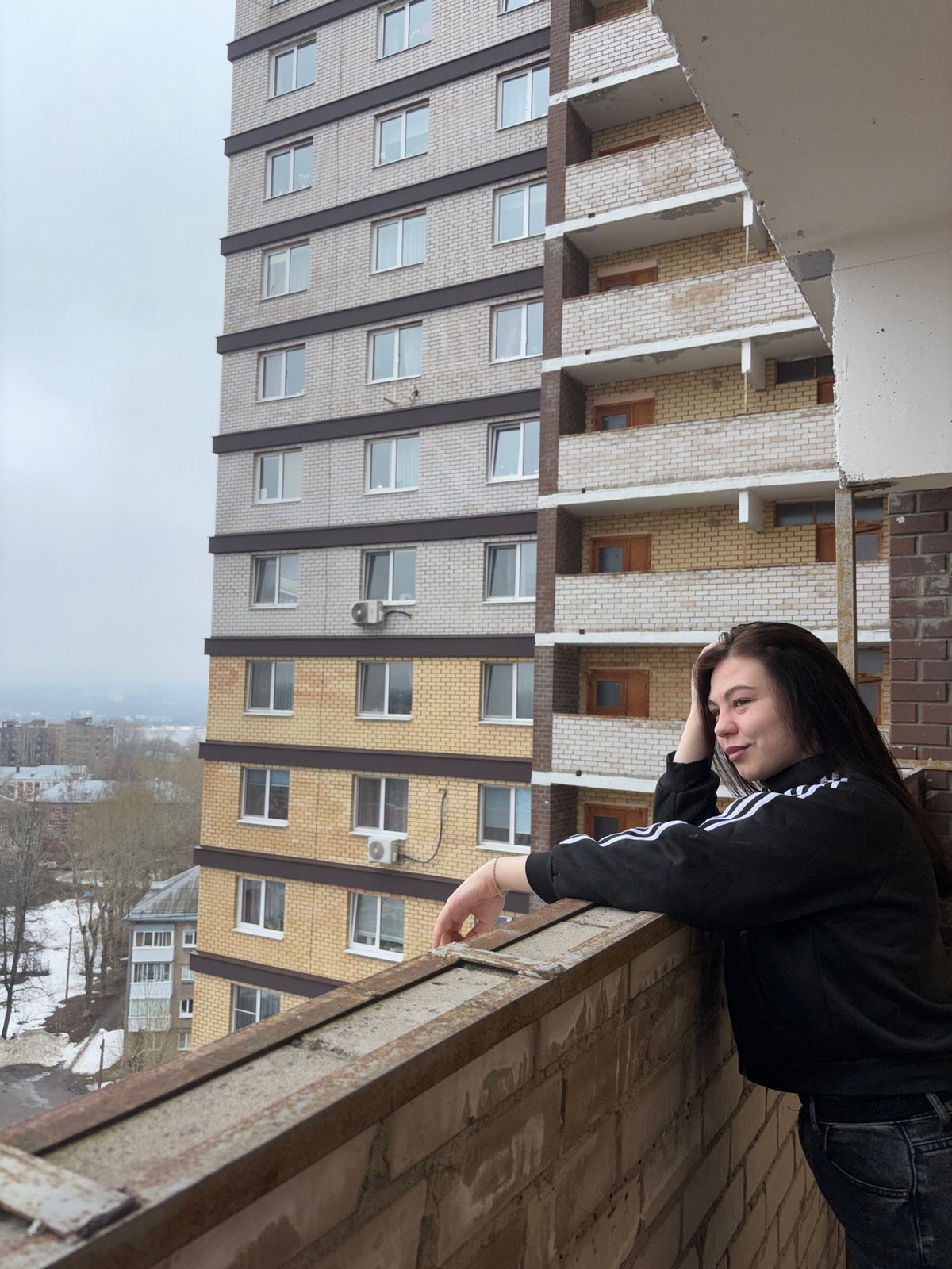 Two people explore unfinished building in Perm, Russia